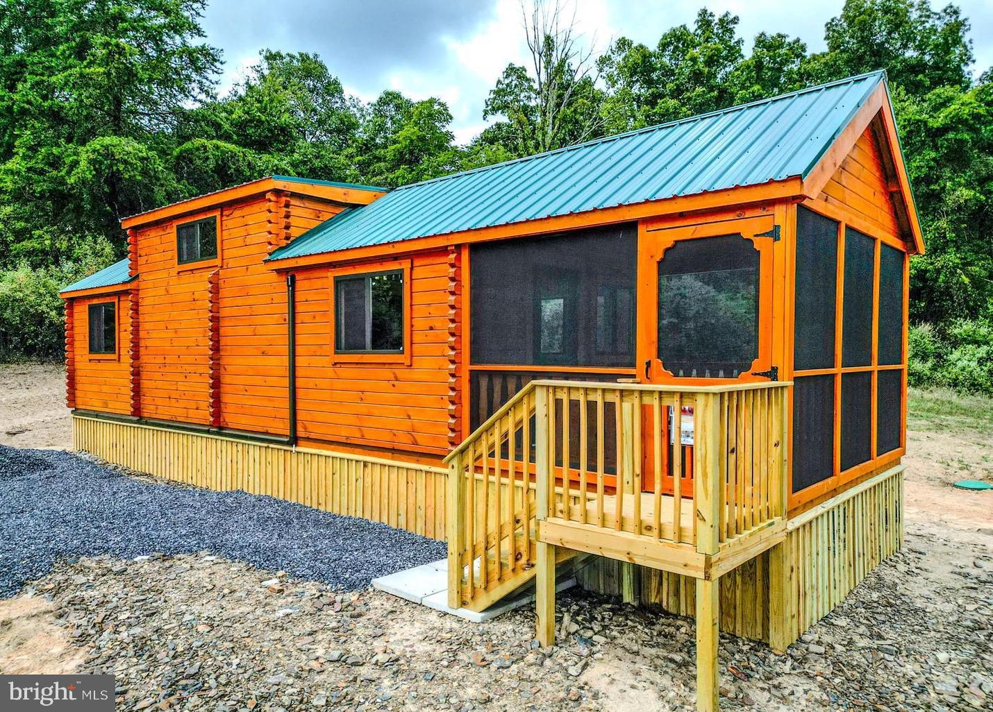 SELLER MOTIVIATED - BIG PRICE REDUCTION!!  **Rustic Yet Contemporary Tiny Home Log Cabin in the Heart of the Appalachian Mountains**  Discover the charm and freedom of living in a true log cabin nestled in the heart of the Appalachian Mountains. This property offers no HOAs to burden or infringe on your freedoms! Whether you're just starting out as a homeowner or considering a real estate investment, you can't go wrong with this delightful cabin.  Owning this property is less expensive then current rental payments.  Investors - the STR opportunities are endless here!  Rustic Yet Contemporary Design!  With functional use of space every inch of this cabin is designed with practicality in mind.  Relax and enjoy the outdoors year-round in any weather on your spacious enclosed porch. The living area offers ample space for a comfortable retreat after a day of adventure.  The fully functional Kitchen includes a breakfast bar for casual dining, all the necessary appliances for convenience with sufficient counter and cabinet space.  Full sized bathroom equipped with all the essentials for everyday living.  The Main Bedroom is 12x10 (approx)  and  can accommodate a king or queen bed with ease or 2 doubles. Washer/Dryer Hookups are included.  There is a Computer/Desk/Storage Area that can easily accommodate bunk beds for additional sleeping arrangements if needed or be utilized as a pantry or large closet.  The massive loft 11x17 (approx) provides space for two queen mattresses, perfect for guests or extra family members.  Mini Split Heat/AC for efficient heating and cooling for year-round comfort that is reliable and convenient.  Metal roof with gutters and downspouts to keep the cabin well-maintained.  Hassle free public water supply.  All situated on an easily maintainable 1.35 acre lot located perfectly near all that West Virginia has to offer, including skiing, fishing, boating, hunting and hiking.  Just minutes off Corridor H/US 48 and close to popular attractions such as Seneca Rocks, Davis/Thomas, Spruce Knob, Vepco Lake, Potomac River, Canaan Valley Ski resorts and Blackwater Falls.  This delightful, affordable, and sensible investment is perfect for anyone looking to embrace the Appalachian lifestyle. Don't miss out on the opportunity to own a piece of mountain paradise before it's gone!!!