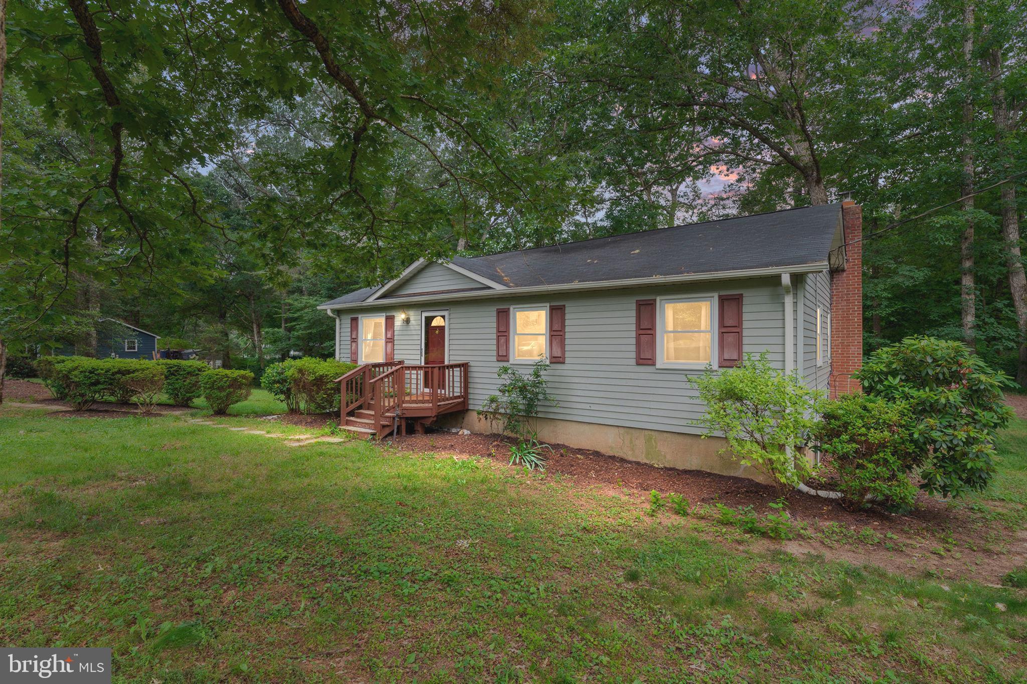 Note - New Deck and Front Steps being installed this week. Rear Sheds being removed. 
Please do not go out on to the rear deck when showing. New deck is being installed but it isn't quite completed. Thank you!
Welcome home to this adorable and affordably priced 3-bedroom rambler, situated in a peaceful setting on a beautifully treed corner lot with mature landscaping.  You'll appreciate the spacious country kitchen and hardwood floors in the living room and hallway. The walkout basement provides valuable additional expansion space and features rough-in plumbing for a future bathroom, plus a cozy woodstove—perfect for creating a future recreation room or expanded living areas.  NO HOA.
Recent updates include:  Washer and Dryer - March 2021, Chimney liner and wood burning stove - November 2022, Hot water heater replaced - December 2022, New AC and Heat Pump and New electrical panel - February. 2024, New gutters and leaf filter - May 2024, Water softener and Acid Neutralizer - April 2025, New Dishwasher - May 2026 and New Deck and Front Steps - June 2026. 

Enjoy morning coffee or your favorite book while looking out to nature on the brand-new deck. Located in a quiet neighborhood that's great for long walks.  There is public lake access just about a half mile away where you could enjoy fishing. This home is tucked away in the back of the neighborhood with light traffic; offering a serene atmosphere while still remaining convenient to shopping needs and I-95.
