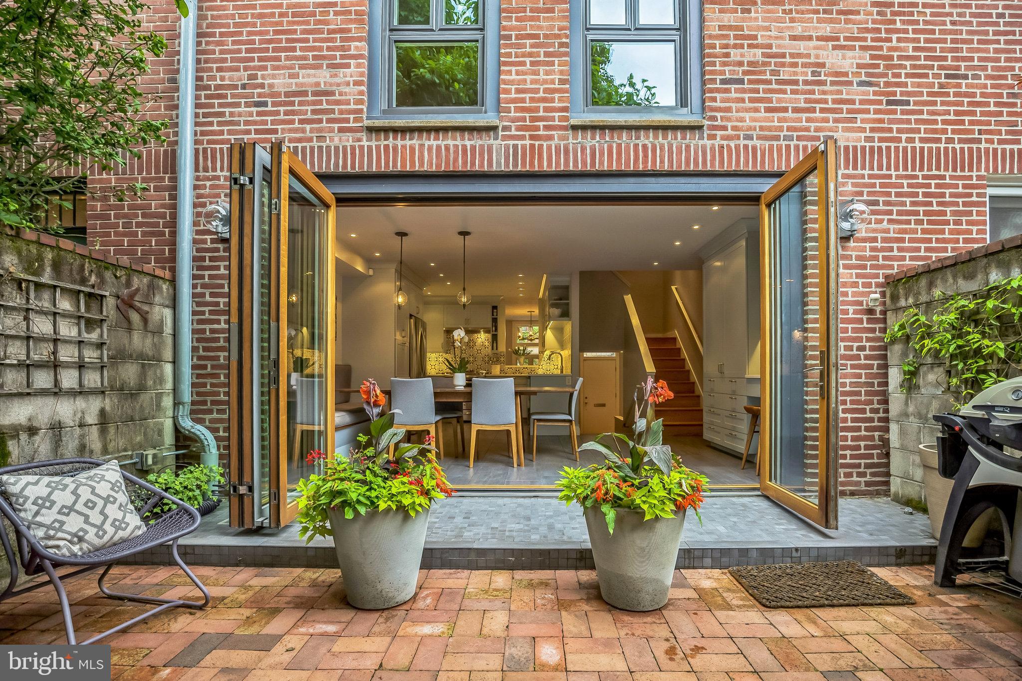 Built in 1968, this split-level row home was fully renovated in 2015, remaining faithful to the original floor plan. The kitchen upgrade, however, combined the cooking and dining areas into one fluid space that opens into the back garden with an expansive wall of folding glass doors. 

Floor to ceiling windows throughout the home allow gorgeous natural light into each room, and custom cabinetry throughout adds ample storage. Deeded parking makes this home a rare find, and tasteful interior design finishes render it not only move-in ready, but a lovely, peaceful retreat in the midst of Center City.

Enter this 3-story home and notice the high ceilings, fireplace, and original oak floors. A custom cubby tucks coats, shoes, and keys out of sight. The kitchen and dining room form the stylish heart of the home, with custom tiles in the backsplash, stainless steel appliances, a banquet, and a combined pantry and work hub. The dining area fits a full-sized table with courtyard views. A magnolia tree shades the backyard, and a private walkway leads to a deeded parking space at 515 Lombard Street (Unit K).

The second floor hosts two bedrooms, each with a full wall of closets, separated by a full bath and linen closet. The third floor features a spa-style bathroom plus a third bedroom that doubles as an office. The back door opens to a new roof that can serve as a sundeck.

In the lower level, a cozy den provides a space to relax, plus a coat closet and powder room. The separate basement offers clean and spacious storage or work space, along with laundry and mechanicals.

Located on a beautiful tree-lined block, with private parking, a roof deck, backyard yard, fireplace, and modern design, a home like 510 Pine Street is hard to come by!