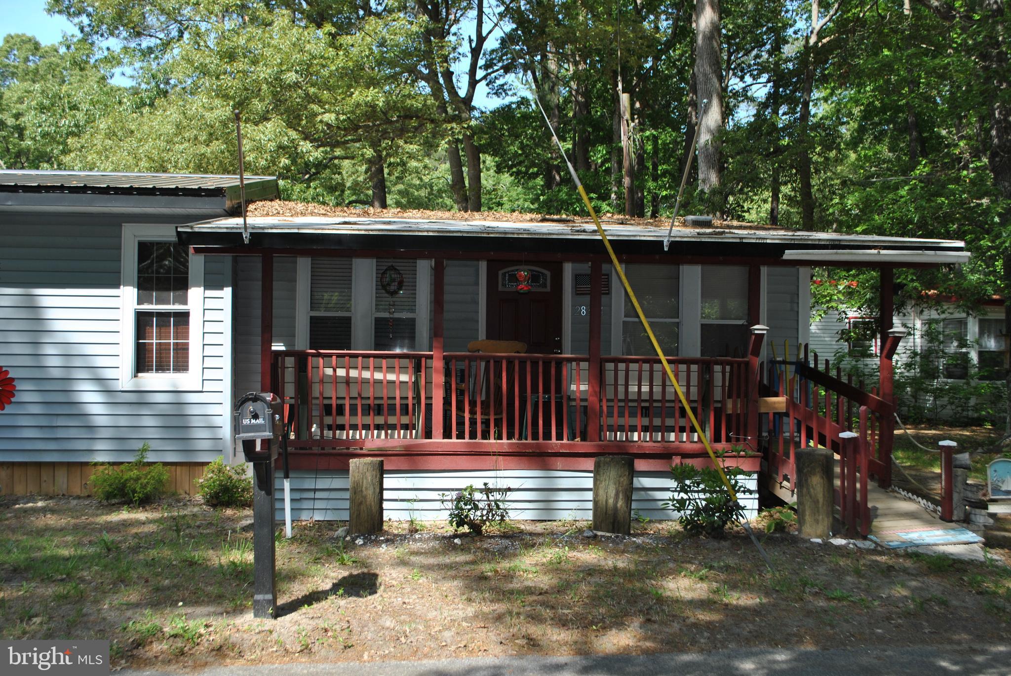 Affordable living near the water. This cottage sits on an extremely large lot and has a recently added
master bedroom and closet!  The covered front porch and screened in back porch add lots of extra living space. The kitchen is open to the living area and back porch, which provides easy access to both.  There are
two extra bedrooms and a full bath with plenty of sleeping area.  The exterior has a fire pit area, two  sheds for storage and a fish cleaning area in between.   There is also a covered structure big enough to store a large boat.  The home comes fully furnished and the new buyers must be park approved.  The private boat club is just blocks away and with easy access to the Indian River Bay.   So grab your fishing rods, put on your party hat or just relax, but don't wait to long to own this great property!
