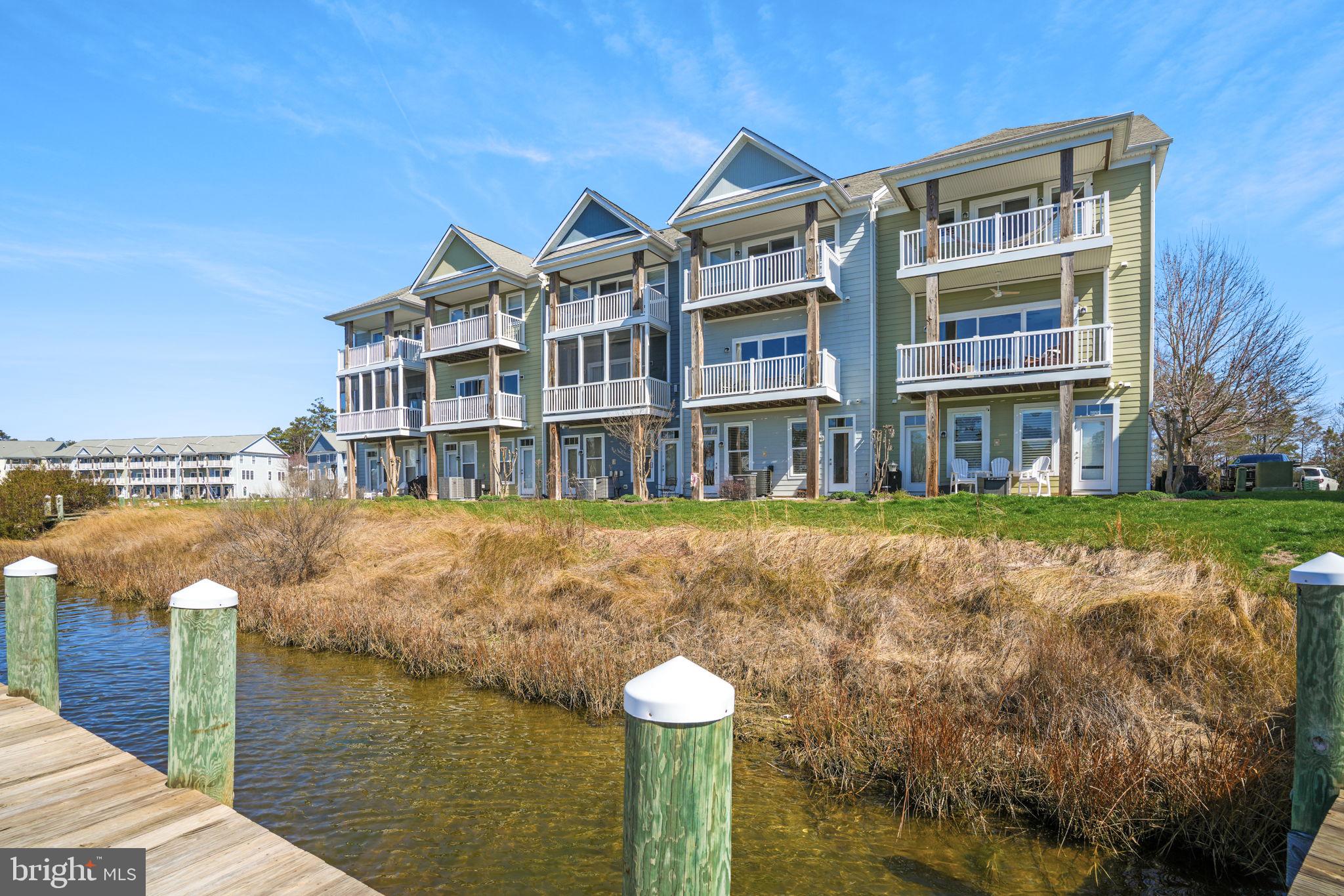 Welcome to 10900 Holystone Lane #402, a refined waterfront townhome tucked within the prestigious gated community of Glen Riddle... just minutes from the beaches, dining, and vibrant energy of Ocean City, Maryland. Perfectly positioned on a private “island” enclave within the sought-after Marina Villas at Glen Riddle, this exceptional residence offers a rare blend of low-maintenance luxury and resort-style living.  Overlooking the marina, this light-filled home offers truly extraordinary views that elevate everyday living into something special. From nearly every window, enjoy a dynamic coastal panorama where nature and waterfront life unfold before you. Watch bald eagles and osprey soar overhead, often returning with their latest catch, while boats glide in and out of the marina below. In the quieter off-season, the setting transforms into a peaceful retreat, while summer brings a lively, ever-changing scene, with the nearby boat ramp offering a front-row seat to all the action and a source of endless, built-in entertainment. This is a home where the views are not just beautiful...they are an experience.  Thoughtfully designed, the residence features three spacious bedrooms and three-and-a-half baths, with a flexible entry-level living space that can easily serve as a fourth bedroom, guest suite, or private retreat. The open-concept main living area invites effortless entertaining, while expansive windows flood the home with natural light and frame the stunning waterfront backdrop.  Lovingly maintained and very gently lived-in, this home reflects pride of ownership throughout. A recently replaced HVAC system offers added peace of mind, while the attached garage provides convenience and additional storage. Within the Marina Villas condominium association, exterior maintenance, including landscaping and upkeep, is expertly managed, allowing homeowners to enjoy a truly lock-and-leave lifestyle ideal for both full-time living and vacation use.
Glen Riddle is renowned for its amenity-rich environment, offering residents access to a private marina, two championship golf courses, a clubhouse with dining (Ruth's Chris Steak House), fitness center, outdoor pool, pickleball/tennis courts, and scenic walking trails. Boating enthusiasts will appreciate the opportunity to purchase or lease boat slips within the community, enhancing the coastal lifestyle experience. Whether you’re seeking a primary residence or a sophisticated second home, this exceptional property delivers unmatched views, convenience, and access to one of the area’s most coveted communities. Experience waterfront living at its finest...where every day feels like a getaway.