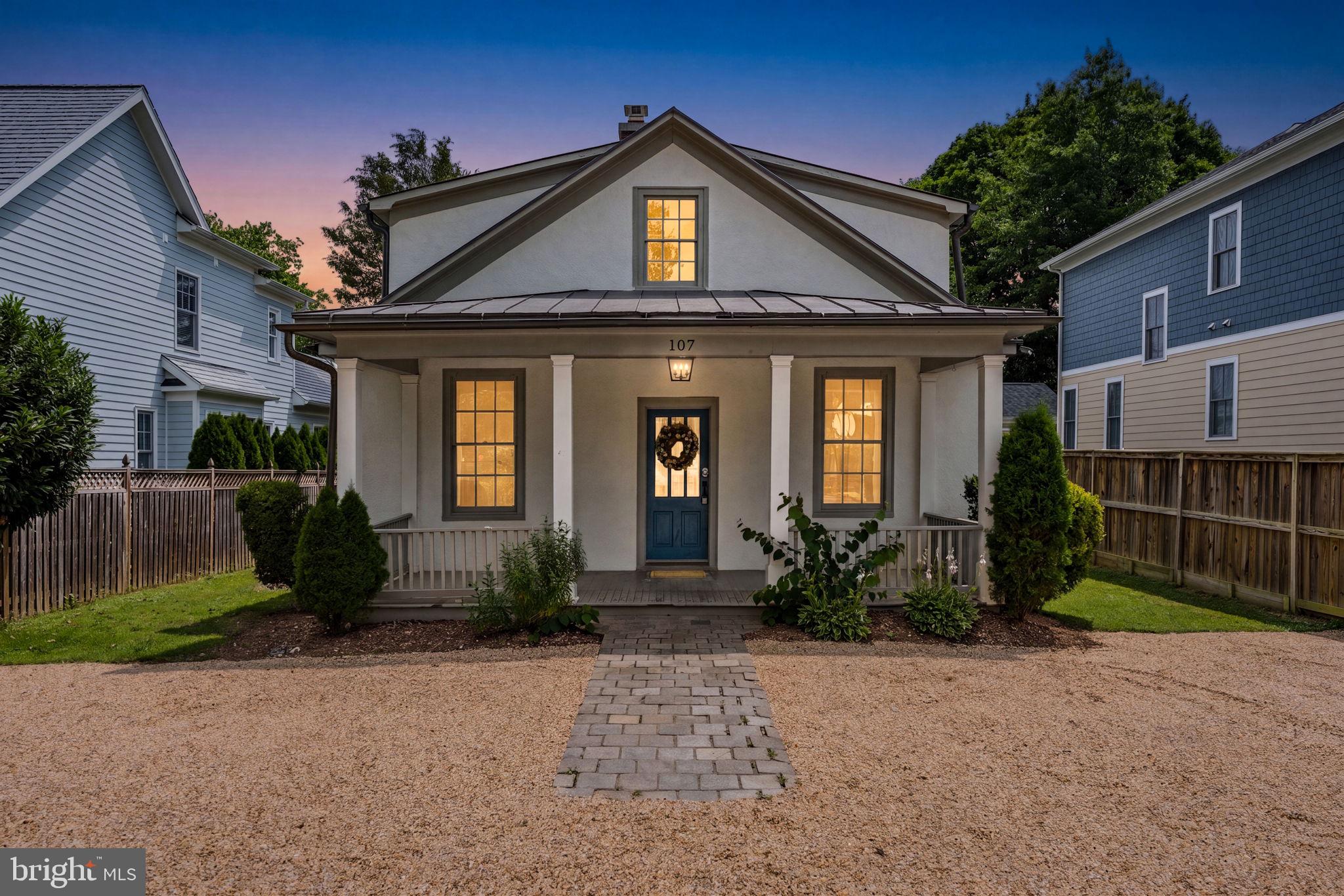 Tucked beneath mature shade trees in the heart of Middleburg, this five-bedroom farmhouse pairs historic character with thoughtful updates. Inside, original heart pine floors run throughout, paired with tall windows, deep crown molding, and the kind of vintage cast-iron radiators that give old Virginia homes their warmth.

The front living room centers on a wood-burning fireplace with a classic painted mantel, while the adjoining dining room offers built-in shelving and a capiz-shell pendant overhead. The kitchen presents a well-sized blank slate, ready for a future owner's personal touch. A first-floor bedroom adds welcome flexibility for guests, in-laws, or main-level living. Upstairs, four additional bedrooms share the same wide-plank floors and generous natural light, served by two full baths with tiled shower surrounds, rounding out the home's three full baths.

Outside, the aerial view tells the rest of the story: a quiet, tree-canopied street lined with charming homes, open pasture and the Blue Ridge foothills rolling out just beyond town. It's classic Middleburg — walkable, historic, and horse-country close, minutes from the village's shops, restaurants, and wine country beyond.

A rare opportunity to own a piece of Middleburg's architectural character with modern-day livability already built in. Note: a new HVAC/AC system is already scheduled for installation, taking one more item off the new owner's to-do list.