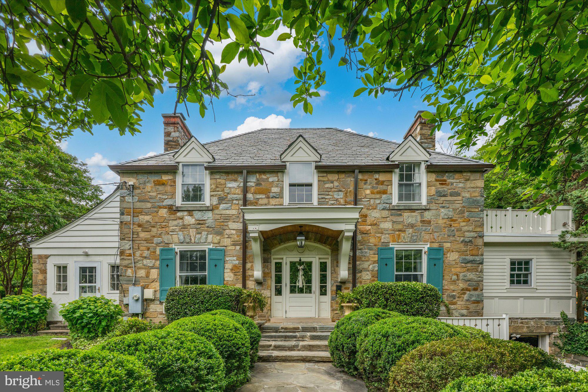 Step into a piece of history reimagined for modern living. Originally built in 1933 and once home to the esteemed Hitt family, this extraordinary farmhouse blends timeless charm with luxurious updates and sophisticated design. Thoughtfully expanded by the renowned builder Natelli, every detail has been curated for elegance, comfort, and functionality across four beautifully finished levels.

The home’s heart is its expansive and light-filled main level, where original character meets thoughtful renovation. The formal dining room sets the stage for elegant entertaining, while the eat-in kitchen, anchored by a custom banquette and rich cabinetry, seamlessly marries form and function. A striking preserved stone wall—once the home’s original exterior—adds warmth and texture. Just beyond, a butler’s pantry with built-in cabinetry leads to a mudroom complete with a secondary refrigerator for added convenience. The gracious formal living room and richly appointed library offer custom built-ins and refined spaces for gathering or quiet retreat, while the inviting family room and elegant powder room complete the main living area.

An exceptional in-law suite, with its own kitchenette, bath, laundry, and private entrance, offers ideal accommodations for guests, extended family, or au pair living—fully integrated, yet entirely independent.

Upstairs, the primary suite is a serene sanctuary with two custom walk-in closets and a spa-quality bath featuring a soaking tub, separate shower, private water closet, and dual vanities. A second ensuite bedroom reflects the home’s original footprint, while two additional bedrooms share a beautifully appointed hall bath. A full laundry room on this level adds ease to daily living. A private second upper level hosts an additional bedroom with generous closet space, offering privacy and flexibility for a home office, studio, or guest quarters.

The lower level features a spacious recreation room, abundant storage, and updated mechanicals.

Outside, the home is surrounded by beautifully manicured, level grounds that invite both relaxation and play. A slate patio with a built-in fire pit creates the perfect setting for alfresco evenings, while a wheelchair-accessible walkway ensures ease of access throughout the property. A dedicated play area, charming tree house, and detached shed offer space for fun, creativity, and storage. The home features additional green space provided by an existing easement with Arlington County. 

A one-car garage completes this exceptional offering. Additional information regarding the existing easement is available upon request.

Rich in heritage yet refined for today, this extraordinary farmhouse offers an unmatched combination of character, craftsmanship, and comfort in a truly unforgettable setting.