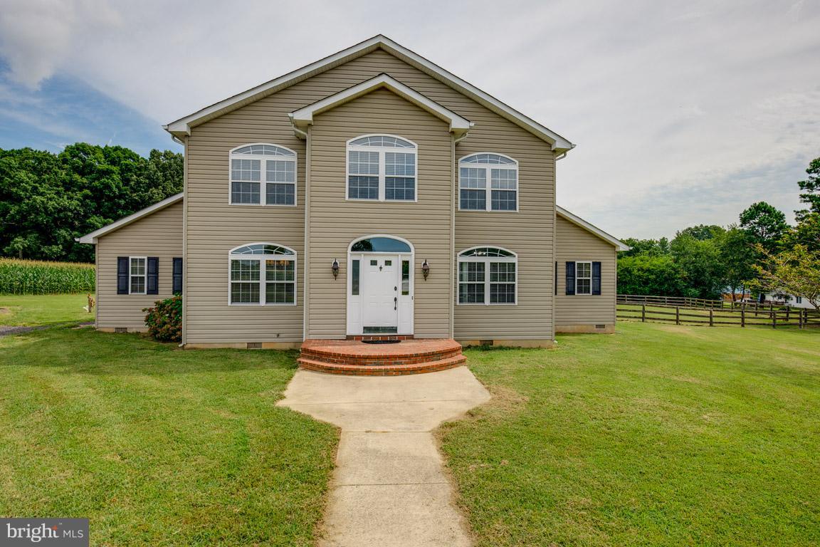 GORGEOUS COLONIAL w/4bdrms, 2.5 bths. Gourmet kitch w/42" cabinets, 5-burner cooktop, dbl wall ovens, walk-in pantry & recessed lights. Cathedral ceil. Wide plank harwood flrs. 1st floor mstr bedrm & bth w/dual sinks/soaking tub/sep shwr. Fam Rm w/gas fireplace. 3 uppr lvl bedrms & full bth.  Laundry rm w/wash sink. Detached 2-car garage w/upstairs storage. RV pad. Wooded view w/nearly 2 acres.