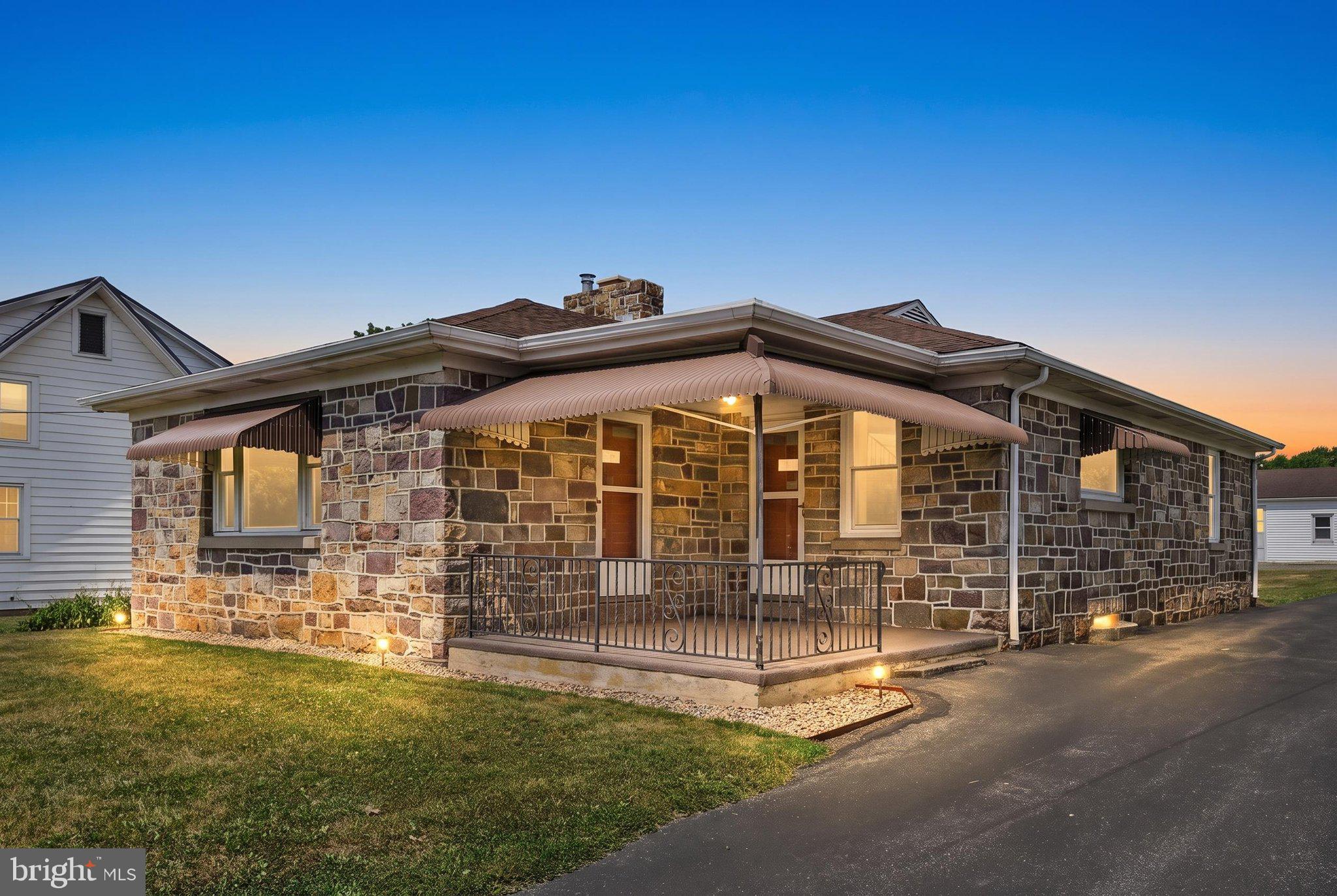 Welcome to this beautifully maintained stone ranch, lovingly owned and cared for by the same family since it was built in the 1950s. Situated on two parcels totaling  0.90 acres, this property offers the perfect blend of country living just minutes from town.
Inside, you’ll find three bedrooms and one full bath, along with a spacious living room highlighted by a stunning  stone fireplace. Original hardwood flooring lies beneath the living room, hallway, and bedrooms, ready to be uncovered by the next owner. The spacious eat-in kitchen offers abundant cabinetry and plenty of room for a dining table.
One bedroom is currently being used as a convenient main-floor laundry room but can easily be converted back into a third bedroom, with additional laundry hookups available in the basement.
The full basement has been recently waterproofed and provides exceptional storage space, room for canning, hobbies, or future finishing possibilities. Step outside to the rear patio overlooking the expansive backyard, where the additional acreage provides level, usable space for recreation, gardening, or entertaining.
A true standout feature is the impressive 1,500+ square foot block garage complete with a built-in vehicle pit, making it an ideal workspace for car enthusiasts, mechanics, or anyone needing extensive storage and workshop space.
If you’ve been searching for a solid, well-built home with timeless character, generous outdoor space, and an incredible garage—all while enjoying a peaceful country setting just minutes from town—this is one you won’t want to miss.  Call to set up your private showing!