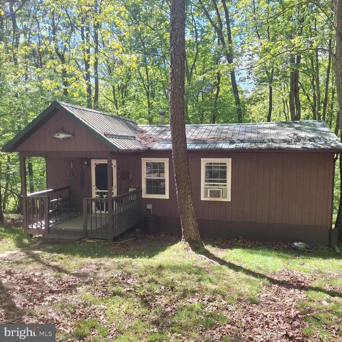 Escape to the mountains with this charming 2-bedroom, 1-bath cabin situated on 2.44 private acres near the scenic George Washington National Forest. Surrounded by outdoor recreation with three nearby lakes and trout streams, this property is perfect for nature lovers, weekend adventurers, or anyone seeking a peaceful retreat. The well-maintained cabin features a cozy wood stove, comfortable living space, and a rear deck ideal for enjoying the quiet surroundings.  (Work from home with High Speed Internet available) Conveniently located just 45 minutes west of Winchester, this property offers the flexibility of a relaxing getaway or full-time residence.