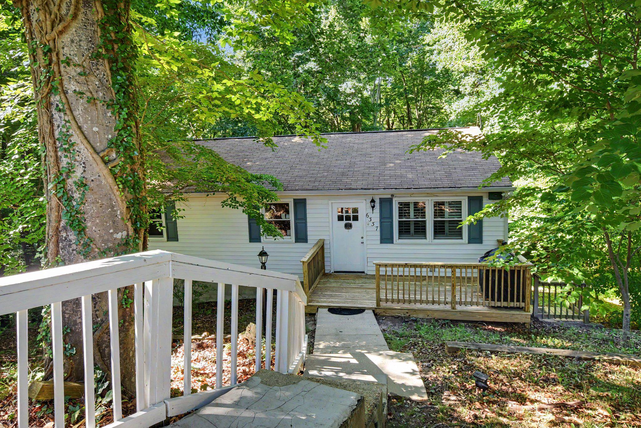 Incredible 2.75% FHA Assumable Interest Rate Available! Escape to your own private woodland sanctuary at the end of a peaceful, quiet cul-de-sac. This enchanting home is truly an artist’s dream, bathed in dappled sunshine and offering a level of tranquility that is hard to find. The interior serves as a creative canvas, currently featuring vibrant custom murals that can remain to inspire the next owner or be returned to a neutral palette—the choice is yours. Beyond its charming exterior, the home offers significantly more space than appears, boasting a versatile layout with two distinct living areas: a shared living space on the upper level and a spacious secondary living room downstairs.

The heart of the home is the beautifully updated kitchen, complete with modern stainless steel appliances and stylish finishes. Durable LVP flooring flows throughout the main living areas, while plush carpeting adds comfort to the bedrooms. This expansive floor plan includes six true bedrooms with two separate living spaces. The upper level features three bedrooms, including a primary suite that serves as a private getaway with its own turf-covered walk-out deck overlooking the trees. For added convenience, the laundry is also located on the upper bedroom level.

The lower level provides excellent separation of space with three additional spacious rooms that can be used for sleeping or are perfect for a home office, playroom, or studio. There is a wet bar rough-in in the lower family room to make this a great hangout spot, or create another Kitchen for a basement apartment with private rear entrance. Major updates provide peace of mind, including two updated bathrooms and a brand-new well pump installed in 2024. Outside, the backyard is primed and ready for a custom patio, offering the perfect spot to host gatherings or simply enjoy the surrounding nature. Combining modern updates, significant financial value, and a serene atmosphere, this home is a rare find for those seeking both function and inspiration.