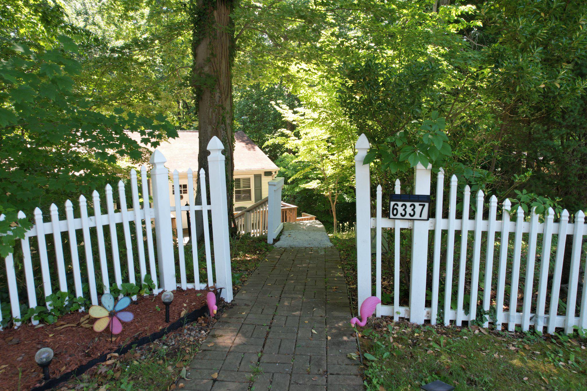 Incredible 2.75% FHA Assumable Interest Rate Available! Escape to your own private woodland sanctuary at the end of a peaceful, quiet cul-de-sac. This enchanting home is truly an artist’s dream, bathed in dappled sunshine and offering a level of tranquility that is hard to find. The interior serves as a creative canvas, currently featuring vibrant custom murals that can remain to inspire the next owner or be returned to a neutral palette—the choice is yours. Beyond its charming exterior, the home offers significantly more space than appears, boasting a versatile layout with two distinct living areas: a shared living space on the upper level and a spacious secondary living room downstairs.

The heart of the home is the beautifully updated kitchen, complete with modern stainless steel appliances and stylish finishes. Durable LVP flooring flows throughout the main living areas, while plush carpeting adds comfort to the bedrooms. This expansive floor plan includes six true bedrooms with two separate living spaces. The upper level features three bedrooms, including a primary suite that serves as a private getaway with its own turf-covered walk-out deck overlooking the trees. For added convenience, the laundry is also located on the upper bedroom level.

The lower level provides excellent separation of space with three additional spacious rooms that can be used for sleeping or are perfect for a home office, playroom, or studio. There is a wet bar rough-in in the lower family room to make this a great hangout spot, or create another Kitchen for a basement apartment with private rear entrance. Major updates provide peace of mind, including two updated bathrooms and a brand-new well pump installed in 2024. Outside, the backyard is primed and ready for a custom patio, offering the perfect spot to host gatherings or simply enjoy the surrounding nature. Combining modern updates, significant financial value, and a serene atmosphere, this home is a rare find for those seeking both function and inspiration.