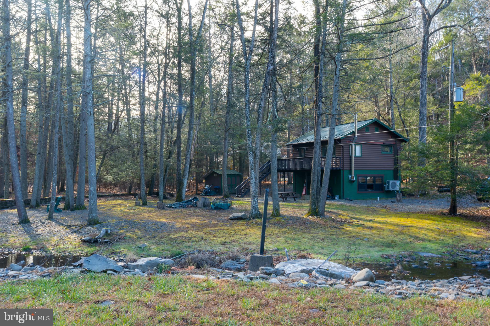 Welcome to a once a lifetime opportunity to own a Pocono paradise, approximately one hour from the New York border, with astounding creek side mountain valley experience. Where you own your own log cabin experience, and an income producing home, that makes it a compound for when you want to use it or other options. SPR permitted with registration/fee in a combination where privacy is unparallel. In what many call this high energy healing location, these inviting properties offers an exciting blend of adventure and relaxation in every season which offers something special, and unique where you can unplug and experience nature, as sellers have for the past 50 years. During which time we have updated this authentic log cabin, natural and manmade stonework and so many features too much to list. On the northeast class A accredited trout stream. 

Year-round enjoyment awaits, cozy winter evenings by the fire or skiing at nearby Shawnee Mountain, and cool summer days along the Bushkill River for fishing, canoeing, kayaking, or simply unwinding outdoors.

2138 Bridge Side Dr with recently renovated modern luxurious 1,144 SQFT.  Features granite countertops, an updated kitchen and bath, split-unit heating and cooling, 2 bedrooms, 1 full bath, and a deck overlooking scenic water views with the soothing sound of the river close by.

Conveniently located approximately 1 hour to the Pocono Mountains and Lehigh Valley Hospital, under an hour to Allentown and Bethlehem, with easy access to I-80 and nearby Stroudsburg’s dining, arts, and shopping.

Don’t miss this unique chance to own this property in one extraordinary setting, schedule your private tour today.