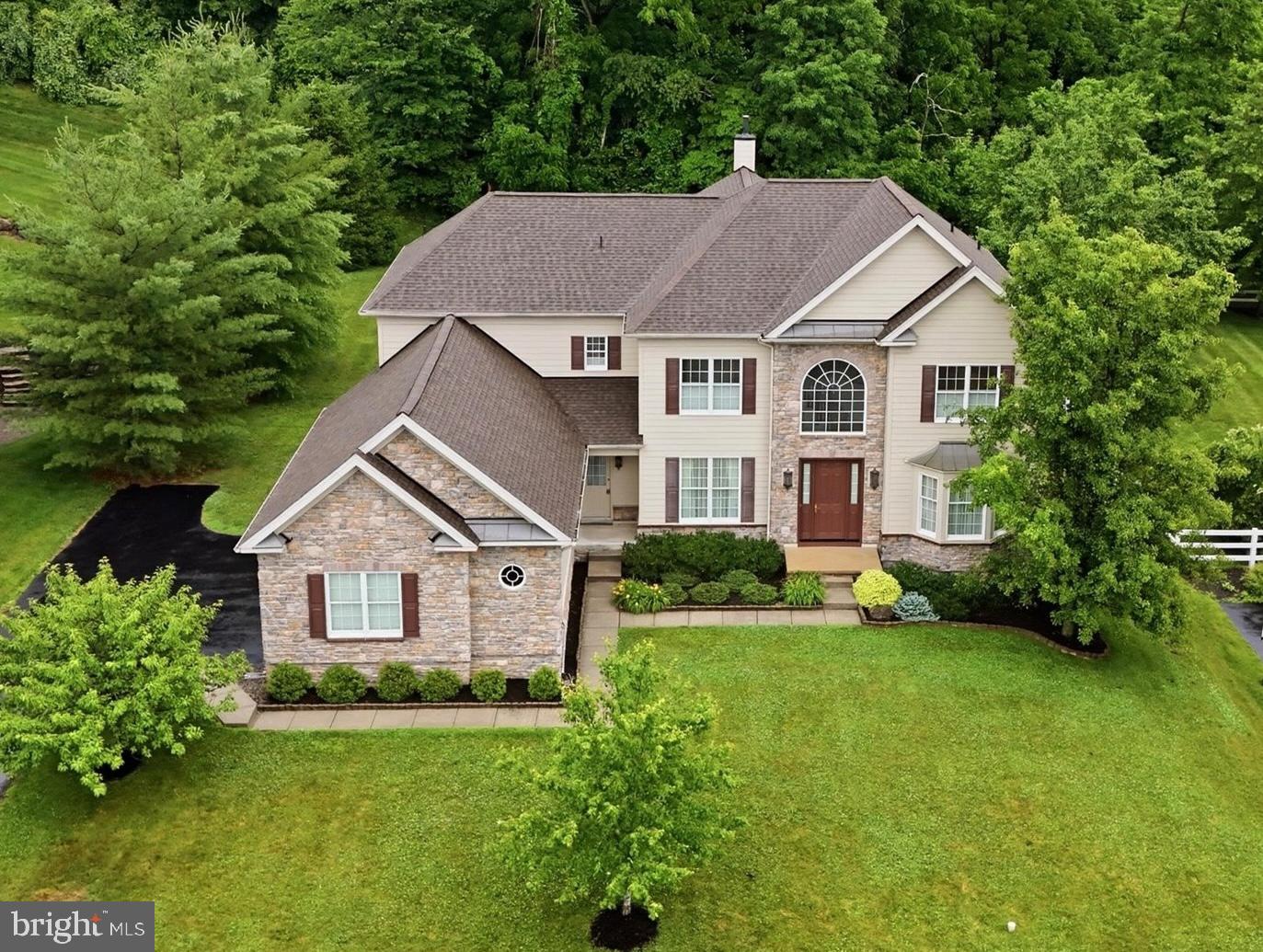 Welcome to 4 Strickland Way, a pristine luxury residence nestled in the highly desirable community of Tall Trees at Thornbury and situated within the top-rated West Chester Area School District. This remarkable 4-bedroom, 3.5-bathroom home perfectly blends elegance, functionality, and modern comfort, showcasing breathtaking panoramic views from a spacious, level lot. Positioned to overlook peaceful community open space in the front and lush, wooded open space in the rear, this property offers unmatched serenity and curb appeal, further enhanced by an extensive exterior renovation in 2018–2019 that updated the siding, stonework, and outdoor lighting fixtures​.

From the moment you step inside, the home's thoughtful design and craftsmanship are on full display. The main level is anchored by a gourmet kitchen equipped with premium granite countertops, a double oven, a bright breakfast area, and a convenient rear staircase. Flowing effortlessly from the kitchen is the dramatic, sunken family room, highlighted by a spectacular floor-to-ceiling gas fireplace that serves as the perfect gathering space. For more structured occasions, the formal living and dining rooms offer sophisticated entertaining options, while a dedicated first-floor office provides a quiet retreat that can easily serve as a flexible 5th bedroom. A convenient powder room, a main-floor laundry room, and a dedicated mudroom complete this level, keeping daily life organized and seamless. For car enthusiasts or those needing extra storage, the spacious 3-car garage connects effortlessly to the home, adding an extra layer of convenience and utility.

Upstairs, the bedroom layouts offer ultimate privacy and upscale comfort for family and guests alike. The expansive primary suite is a true sanctuary, featuring a grand double-door entry, a tray-ceiling​, two massive walk-in closets, ​a sitting room with beautiful views, and a lavish 6-piece en-suite bath. The second bedroom serves as a perfect guest or au pair suite, complete with its own private walk-in closet and dedicated en-suite bathroom. Meanwhile, the spacious and bright third and fourth bedrooms are cleverly connected by a shared Jack-and-Jill bathroom.

Beyond the main living spaces, this property offers incredible long-term versatility and immediate outdoor enjoyment. Step outside through the breakfast area or family room onto the brand-new composite deck, added in 2025, which serves as an ideal oasis for relaxing or grilling against a wooded backdrop. Indoors, a massive, 2,100+ square foot unfinished basement provides a clean, blank canvas just waiting to be transformed into a home theater, gym, or ultimate game room.

Best of all, this home is in remarkable, move-in condition, offering total peace of mind with all major big-ticket items recently replaced. Capital improvements include a brand-new roof installed in 2024, a new water heater from 2023, and a high-efficiency, dual-zoned gas heat and central air conditioning system replaced entirely between 2023 and 2024. Don't miss the opportunity to own this Thornbury masterpiece—schedule your private tour today!