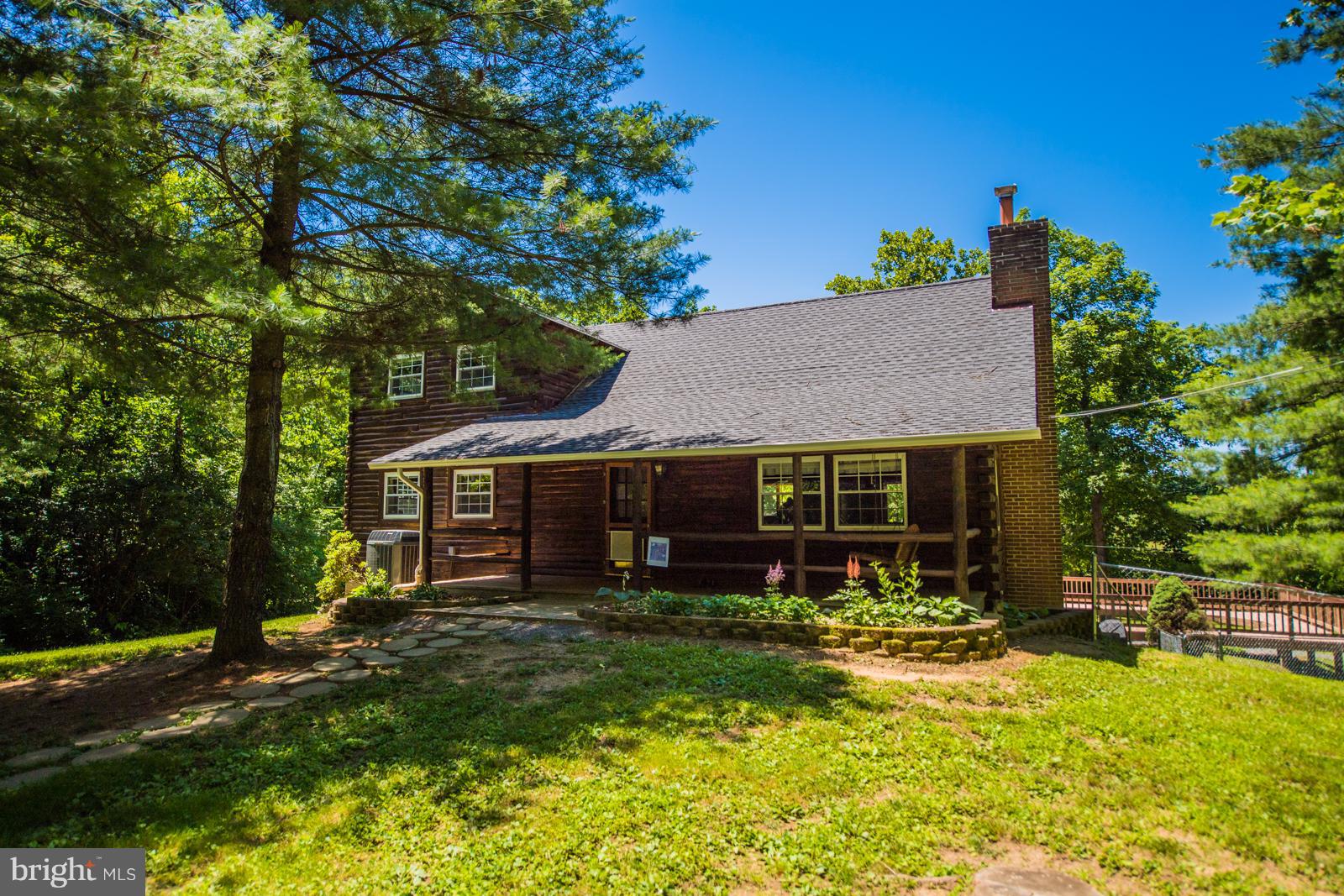 REDUCED! 3 bedroom, 3 bath, cedar log home sits on the Opequon Creek with over 350' of frontage!  Fish and kayak from your own back yard.  Great decking with surround in place for an above ground pool or fill in and create terraced decking.  Cathedral ceilings, beams, stone FP, front porch all on 2.39 ac park like setting. Huge detached garage with plumbing, electric, wood stove and bonus room.