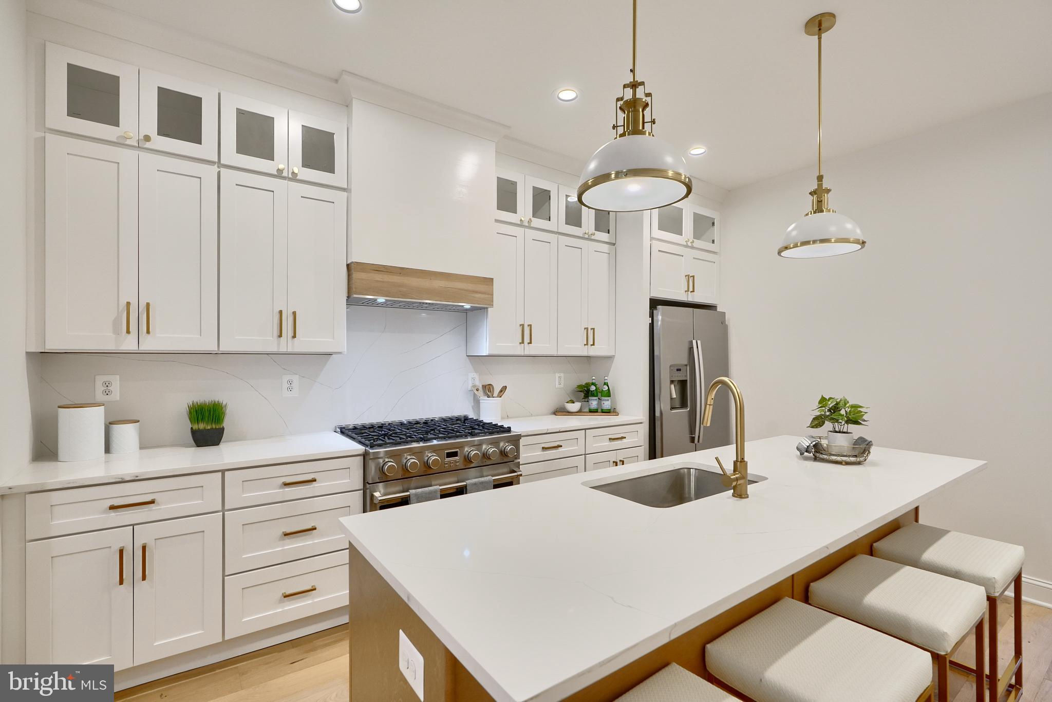 Welcome to 1353 Hull St, a full gut renovation with an incredible 10 year CHAP tax credit! Including 4 above-grade bedrooms and 3.5 bathrooms, this amenity-rich rowhome offers timeless finishes and is sure to impress! Wide plank hardwood floors flow throughout the spacious main level, which has an open floor plan that is perfect for entertaining. The Living area is spacious and has ample room for furniture and is anchored by an exposed brick wall and leads to a dedicated dining room. The kitchen is an absolute stunner and includes quartz countertops, a large island, a professional-grade range, cabinetry that runs to the ceiling and a vented range hood. The main level is completed by a half bathroom and access to the two car parking pad. Upstairs offers a primary suite with a massive en-suite bathroom, large closets and a large floorplan. There's also access to laundry, a spare bathroom and guest bedroom. The third floor provides two additional large bedrooms and a hall bathroom that rivals most primary bathrooms in the neighborhood. The home is completed by the massive rooftop deck that offers panoramic views of Locust Point and downtown Baltimore. With ample storage space in the basement, you'll never have a problem storing your seasonal items! Meticulously renovated and designed, you will be hard pressed to find a higher quality home with all of the benefits that 1353 Hull St provides in the area.