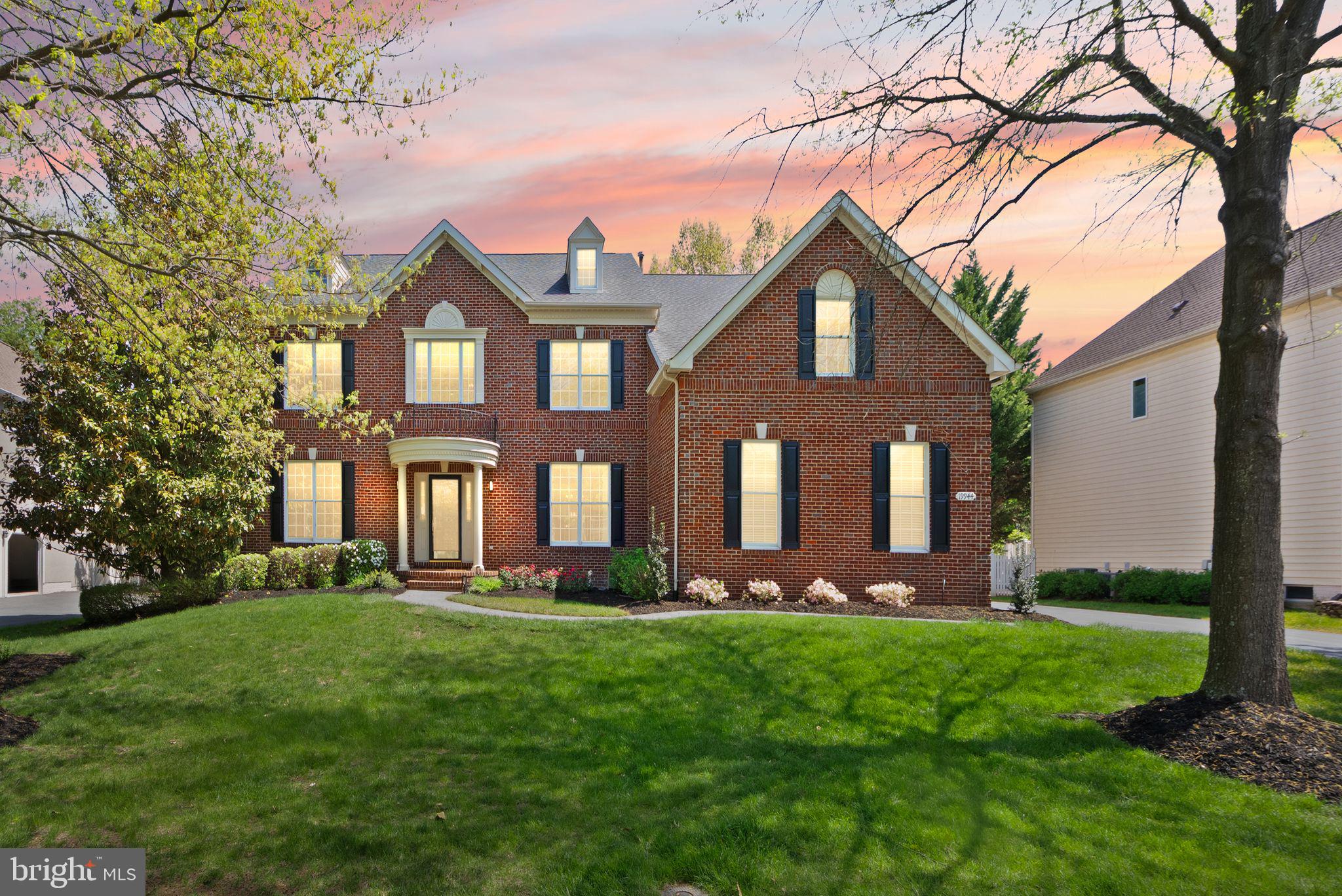 Open House Sunday June 7th 2 PM to 4 PM. A Rare Offering in Belmont. Set on more than a third of an acre in the prestigious Belmont Country Club gated community, this stately brick Colonial presents a rare combination of space, privacy, and resort-style amenities. Offered for the first time by its original owners, this is a property that reflects true pride of ownership, with extensive updates designed for comfort, convenience, and elevated living. A three-car side-load garage and custom portico introduce the home, opening to a two-story foyer with dramatic T-shaped stairs and refined moldings beneath a statement chandelier. Richly refinished hardwood floors run throughout the main level, connecting formal living and dining rooms that provide flexible space for entertaining and everyday relaxation. The heart of the home is a grand-scale family room with soaring ceiling heights and skylights above a gas fireplace and a wet bar. The chef’s kitchen is beautifully remodeled to feature white cabinetry, quartz countertops, a new backsplash, stainless steel appliances, wine fridge, an eat-in dining area, and a center island, with an adjoining sunroom that flows naturally out to the rear deck. A laundry room with upgraded front-loaders completes the main level. Upstairs, the primary suite lives like a private retreat, with a sitting room, tray ceiling, and an exceptionally large walk-in closet. The primary bathroom has been renovated to spa-like luxury, featuring a soaking tub, glass shower, heated floors, a smart toilet, and designer finishes. The upper level also includes a junior suite with a full bath and two additional bedrooms sharing a Jack-and-Jill bath. Downstairs, the redesigned lower level adds an expansive recreation room with a fully equipped bar and kitchen area, an exercise room with a dry/steam sauna, a cedar closet, and a nanny suite with full bath that provides comfort and privacy for guests or live-in support. An expansive unfinished area is suitable for a workshop, storage, or future customization, and a short walk-up leads directly to the exterior. Step into the backyard and imagine the possibilities: ample space to design a custom pool, room to expand, and endless potential to create your own outdoor sanctuary. The patio by the pergola is reinforced to support a large hot tub, making it easy to bring a spa‑like experience outdoors. Premium upgrades include Schonbek lighting in the dining and bathroom, EV charging in the garage, and remodels of the kitchen, primary bath, and hardwood floors within the last five years. Enjoy comfort and peace of mind with fresh interior paint and a newer roof, garage doors, and water heater. Both HVAC systems were replaced in 2021. Belmont Country Club residents enjoy an Arnold Palmer-designed 18-hole golf course, a 35,000 square foot clubhouse with Virginia-inspired architecture, multiple pools, tennis, basketball and volleyball courts, walking trails, a fitness center, playgrounds, and the historic Belmont Manor Home, along with clubhouse dining and a full calendar of social programs. High-speed internet, cable, and full lawn and landscape maintenance are included. Top-rated schools, premier shopping and dining, parks, and easy commuter access place the best of Northern Virginia just beyond the gates. A rare chance to own a meticulously maintained home in one of Loudoun County’s most established communities.