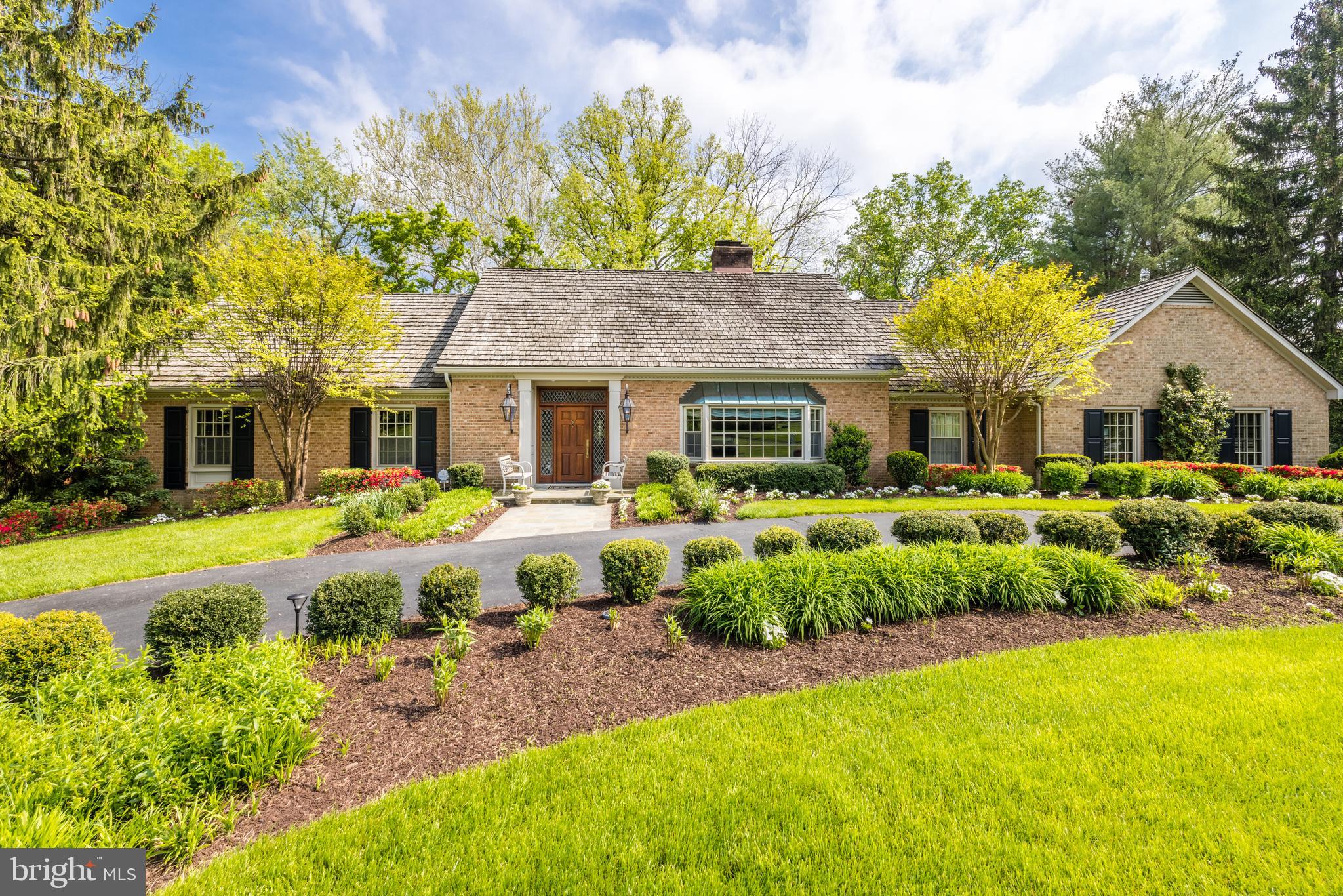 This Southern style cape exudes timeless elegance. From the
welcoming gas lanterns to the covered terrace overlooking a lush
landscape and pool, each space is designed for gracious living and
entertaining. Enjoy the charm and warmth of this mint condition
house with 5700 sf of living on three levels with a side load garage and
circular drive on a quiet cul-de-sac with plenty of parking. A mahogany
gate in an ivy-covered brick wall leads to the fully fenced backyard
lovingly landscaped over 25 years with flowers and plantings. Inside,
meticulous renovations highlight rich millwork and upgraded details
throughout the main level with a floor plan to accommodate any life
style and great flow inside to outside. The custom entry with leaded
glass sidelights and transom lead to a marble foyer and gleaming
hardwood floors through the main and upper levels. Off the foyer a
bookshelf-lined study, including lighted mahogany display cases, leads
to the main level master owners suite with two walk-in closets and a
luxury marble bath with oversized shower and bathtub. The spacious
dining room features two chandeliers and built-in lighted china
cabinets, with a gas fireplace and large bay window. Take a few steps
into the sitting room for cocktails or coffee with your guests. The
sumptuous family room has a handsome stone fireplace surrounded by
custom built-ins with sconces and accent lighting, and French doors
lead to the covered, open air terrace. There is a bar with a beverage
refrigerator and separate icemaker. The sun drenched custom
designed kitchen features inset cabinetry with mirrored doors, and
honed white marble countertops. Top of the line stainless steel
appliances include Wolf, Bosch and Liebherr, and the long center island
is topped with walnut. The breakfast nook showcases a built-in double
china cabinet and a large box window offering beautiful backyard
views. Wainscoting lines the hallway from the kitchen leading to a
powder room, mudroom desk, and the laundry room with two extra
refrigerator/freezers and custom cabinetry. The garage also features
extra cabinetry plus two cabinets to hide garbage cans, and a utility
sink. The upper level boasts an extra wide hall and four bedrooms,
one en suite. Upper level storage includes two linen closets and two
large attics. The airy walkout lower level includes an expansive
recreation room with a full wall of custom wood built-ins and a corner
stone fireplace and French doors to the patio and pool area. In
addition, there is a bedroom and full updated bath with shower, a wet
bar and huge storage room with door to the backyard and covered
patio. The thoughtfully designed outdoor areas offer all sorts of options
for large formal soirees or small intimate gatherings. Stone steps lead
to gardening areas and a new garden shed. Enjoy the privacy and
tranquility of living off a cul de sac just 12 minutes to the White House. 
Hiking and biking trails, parks, playgrounds and swims clubs
are walking distance or minutes away.