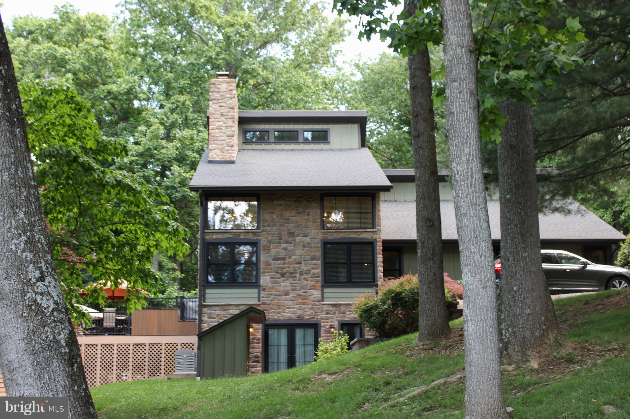 A distinctive contemporary home in desirable Thornbury Township, Delaware County, offering top-rated schools, low taxes (NO TOWNSHIP TAX-$7115 TOTAL), and an exceptional West Chester location. On over three beautifully maintained acres, this property delivers outstanding value in a highly sought-after area. Set on a scenic blend of open meadow and wooded privacy, this 4-bedroom, 2-bath home offers the ideal balance of luxury, technology, and everyday comfort just minutes from West Chester and Media, with convenient access to Philadelphia and the International Airport.

Thoughtfully updated throughout, the home has undergone extensive exterior and mechanical improvements within the last four years.  Included are new insulation, siding (LP Smart Siding), windows, roof, gutters, flashing, a 4-zoned Geo-thermal furnace, whole house generator, and tankless water heater (2025) providing lasting efficiency and peace of mind. Inside, natural wood flooring flows throughout the main living areas, complementing a versatile layout designed for modern living. The expansive family room serves as the heart of the home, featuring soaring ceilings, striking designer light fixtures, and a dramatic double sized fireplace that creates a bold architectural focal point. Lutron smart wood blinds automatically adjust with the sun’s intensity and direction, enhancing both comfort and efficiency while maintaining a refined, modern aesthetic. Three bedrooms are located on the main level, including one currently used as a sophisticated home office featuring wall-to-wall and floor-to-ceiling custom built-ins and a wet bar with wine refrigerator.

The second level is dedicated to a private primary suite retreat, featuring a spacious bedroom with a fireplace (provisioned for propane), automated Lutron smart blinds that adjust with sunlight, and a conveniently located laundry area. The renovated spa-inspired primary bath showcases a floating double vanity and mirrors programmable for gradual illumination, creating a calm and elevated daily experience.

Again, set on over three beautifully maintained acres, the grounds offer exceptional privacy and tranquility, with rolling lawn, mature landscaping, a 3-tiered composite deck stepping down to paver patio ideal for fire pit. Rounding out the home is an unfinished walk-out basement with french doors onto level patio.Combining acreage, privacy, smart-home functionality, and low-maintenance living in a premier West Chester location, this is a truly unique offering in today’s market.