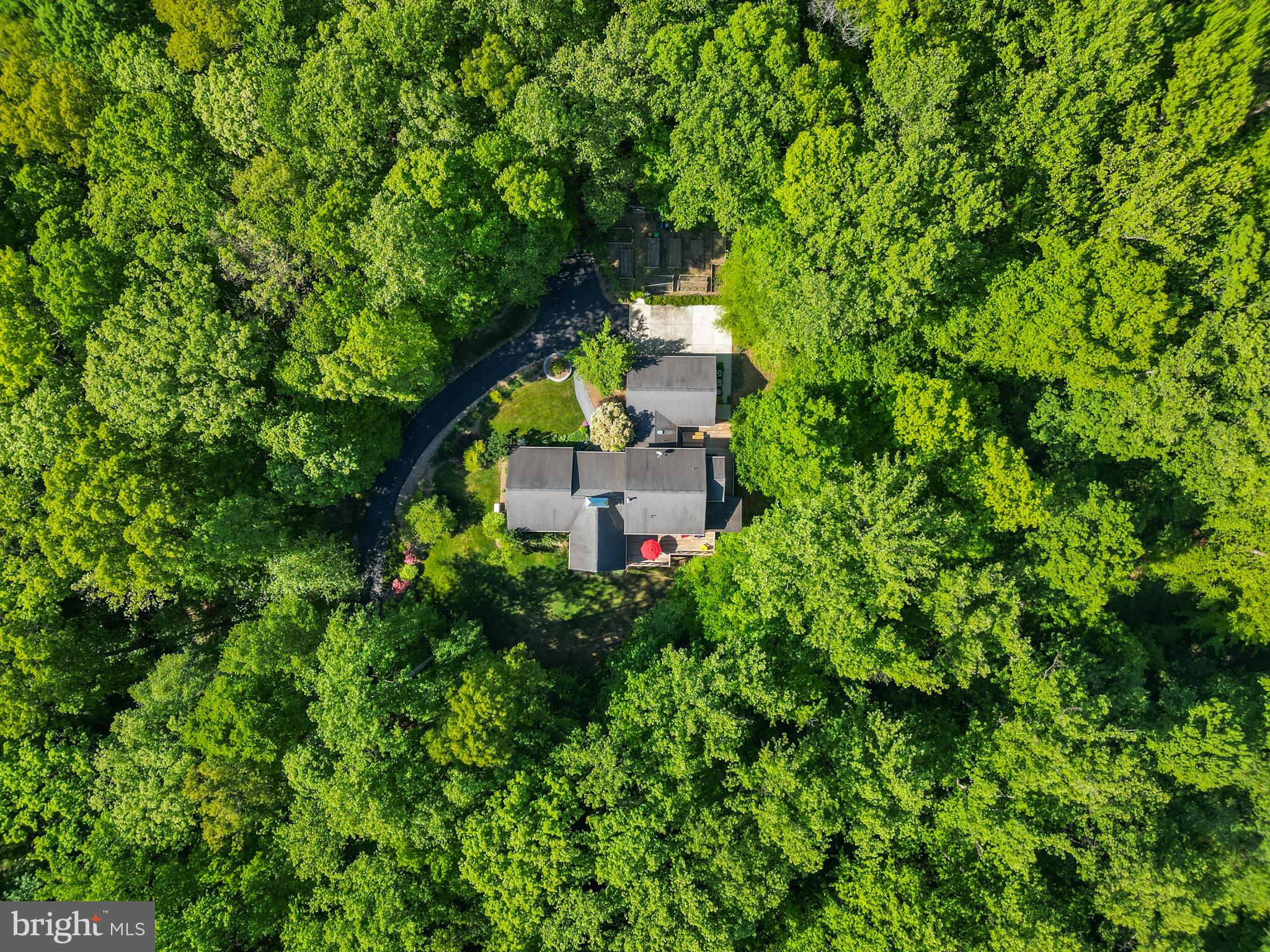 Perfect for the multi-generation family. This 7,000. sq ft  Custom home is located on 15.4 wooded acres of complete privacy yet only minutes from all that Bowie has to offer and major commuter routes.  This custom built home comes with amazing details from top to bottom.  Main level features primary bedroom with updated bathroom walk in shower, walk in closets, Main Livingroom with Two story stone fireplace 
 10 foot vaulted ceiling and wall of windows to enjoy that beautiful view.  Hardwood floors thru the main level, Kitchen comes with custom cabinets, upgraded appliances and overlooks a large family room and dining area. Mudroom off the 3 car garage, Screen porch and tons of exterior living space.  Upper level comes with an additional primary bedroom, Two bedrooms very generous in size and a full bath. Last but not lease the lower level is finished with a walk out open space entertainment area, two additional bedrooms or office space, wet bar area that could be made into an extra kitchen, and storage space. This home makes you feel like you are on your own private mountain .