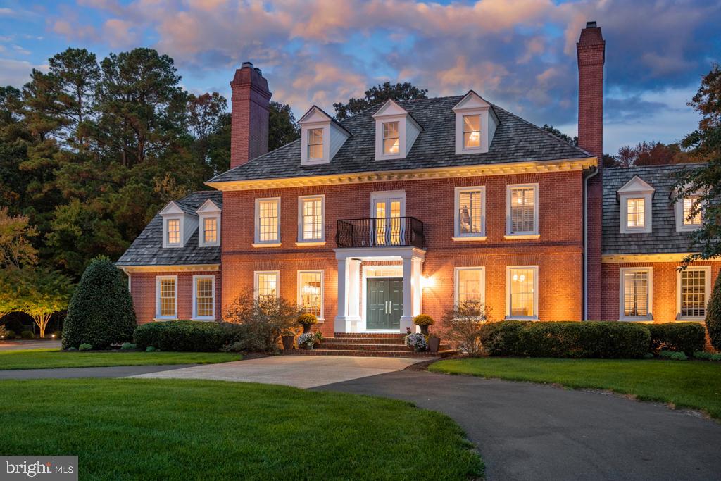 32059 Conleys Chapel Road is simply in a class of its own! This unbelievably beautiful coastal estate sits on nine private acres with a wooded backdrop, meticulously manicured gardens, hardscaping, and lighted natural ponds with fountains. Close to Lewes and Rehoboth Beach, this estate is an unmatched blend of refined country living and a laid-back coastal lifestyle. Inside, you’ll find 4-5 bedrooms, each with an ensuite bathroom, spread across three thoughtfully designed levels and accessible by elevator. A chef’s kitchen is the anchor of the home with English cabinetry by renowned designer Mark Wilkinson, Italian marble tile, a glass vaulted ceiling, gas and induction cooktops, a steam oven, and an expansive butler’s pantry – all perfect for effortless entertaining! The home also features four fireplaces, formal living and dining rooms, rich hardwood floors, and architectural trim, weaving craftsmanship and style throughout every room. The second floor features a primary suite with a sitting room, a large bathroom, and a spacious walk-in closet, as well as three additional bedrooms with wood flooring and architectural trim. The third floor features a large guest suite with an open-air bathtub and plenty of flexible spaces, perfect for private offices, additional bedrooms, a yoga/exercise room, a playroom, or more! The indoor heated lap pool, with cathedral ceilings, skylights, a full bath, a wine refrigerator, and multiple lounge areas, brings a touch of resort-like style to an already impressive estate. A second laundry area is located near the pool, making clean-up easy! Outside, a hot tub, firepit, and horse-ready acreage round out the estate. An attached two-car garage, detached three-car garage, two-zone geothermal HVAC, a full irrigation system, and a carriage house with conversion potential complete the property. For those looking for an exquisite estate nestled in beautiful Sussex County, 32059 Conleys Chapel Road is a dream!