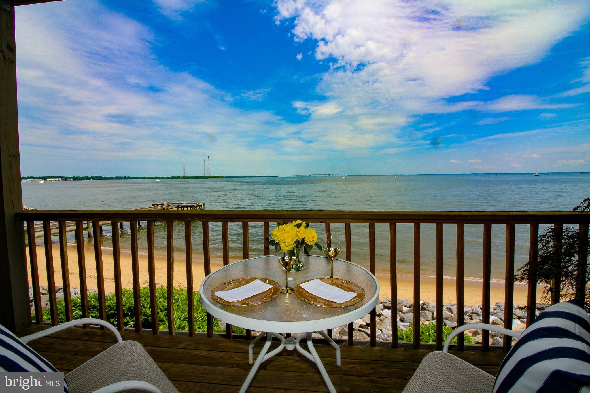 Panoramic water views of the Chesapeake Bay and the Eastern Shore are enjoyed throughout this exclusive home. Facing East, you start your day with panoramic sunrises. During the day you have front row seating for all the boating activities and sailing races where the Severn River meets Chesapeake Bay. This Townhome with elevator is located at the water's edge where the soothing splashing of the waves meets the rocky shore.
The home features 4 bedrooms and 4 full bathrooms. There is a family room with electric fireplace, closet, and full bath.  Just step outside to your private beach level patio and enjoy the views of the Bay and the Bay Breezes. Enjoy fabulous water views from the kitchen, dining room, living room and front deck. A wonderful open space for family and friends to relax and enjoy this water view location. Imagine a pleasant evening meal looking out over the Bay from your private deck! The main bedroom looks out over the Bay, has a large ensuite bath, walk in closet and private deck. A terrific location to finish your busy day with a beverage watching evening Bay activity.  Also featured is a large office with water views that provides space to work at home. Rare in a townhome, this home features large storage areas including the attic with pull down stair access.
The community amenities are a pool overlooking the Chesapeake Bay, Tennis and Pickle Ball Courts, Sandy Beach with fishing piers, and Beach Boat storage and launch area. Also available is the deep-water marina with inlet access directly into the Chesapeake Bay, and the “Beacon” onsite tavern.
Located for easy access to all Annapolis has to offer by way of the Naval Academy, St John’s College, multiple restaurant and shopping venues, the arts, major highways, bus, train, and air travel.  The envy of many a waterfront home buyer this property is now ready for your inspection.  Call to arrange your tour today.