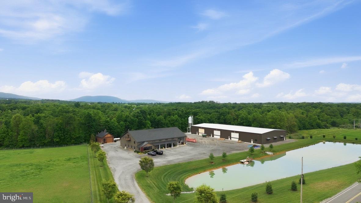 An exceptional commercial opportunity offering a fully equipped, multi-building contractor and operations complex on a well-appointed property in Cumberland County. Purpose-built across three structures with a stocked pond of approximately one acre, this property is designed for serious operational efficiency and is move-in ready for a wide range of commercial uses.

Constructed in 2019, the 6,000 SF (60'x100') contractor shop features 16' ceiling height, six bays with 14' doors, one drive-thru bay, mini-split HVAC, four private offices, a conference room, and a break room with kitchen. Security system installed.

Added in 2022, the high-clearance warehouse offers 20' ceiling height, one drive-thru bay with 16' clearance, four 16'x16' overhead doors, and six propane heaters. The warehouse is measured at 90'x200', 18,000 sqft and consists of steel construction.

Situated at the front of the property is a 1 acre fully stocked pond.

Rounding out the complex, the 22'x30' wash bay — also built in 2019 — is equipped with radiant floor heat, a soap system, accumulator boiler, and mini-split HVAC.

Supporting the entire property is a robust infrastructure package including insulated automatic doors throughout, buried well and sewer, a 1,000-gallon propane tank, and a Katolight backup generator (Model 230 | 440K BTU | Propane | 3-Phase | 240 Amps) ensuring uninterrupted operations.