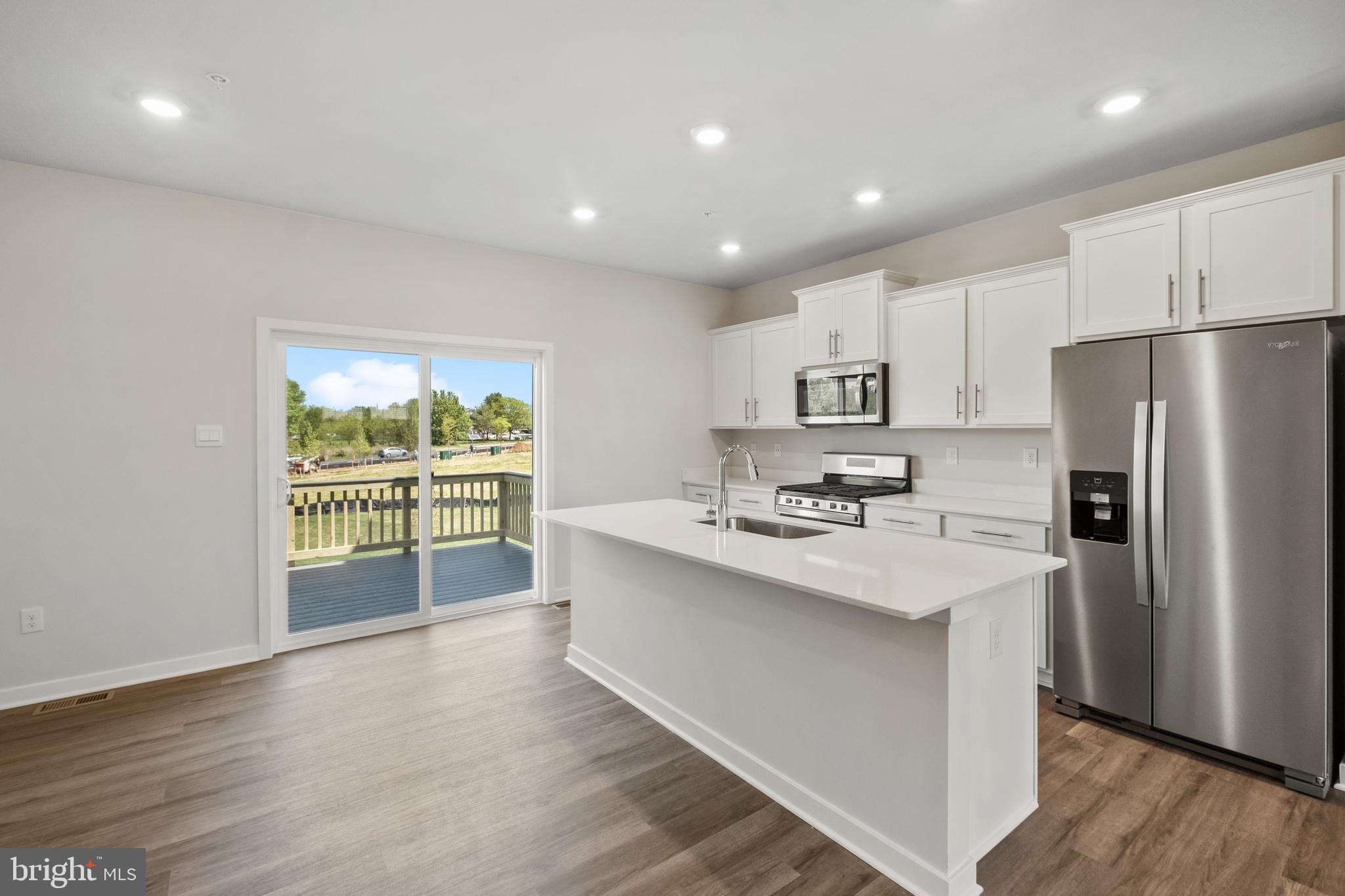 GREAT VALUE. QUICK MOVE!! NEAR AMENITIES. This townhome is located near community amenities! This Lafayette townhome offers1,969 square-foot, with 3 bedrooms, 3.5 bathroom, an 12X10 DECK INCLUDED and 1 car front load garage. There is plenty of space for entertaining family and friends in your finished lower level den w/ full bath on the lower level and den leading you to backyard green space. 
 The mail level offers an open concept living area, features a rear island kitchen with Stainless Steel Whirlpool kitchen appliances with 5-burner gas range, upgraded PANEL White Cabinets and Quartz Counter tops. Hard surface flooring in the lower level den and main level. The third level has a gorgeous owners suite with a large walk-in closet and features a luxury owners shower with Quartz counter tops. Two secondary bedrooms, upper level laundry, and hall bathroom with White Quartz counter tops.  This home is also equipped with smart home technology. The package includes a keyless entry, Skybell (video doorbell), programmable thermostat to adjust your temperature from your smartphone and much more. Commuting and shopping is made easy with quick access to 1-495, Route 5 and to the Washington DC area.