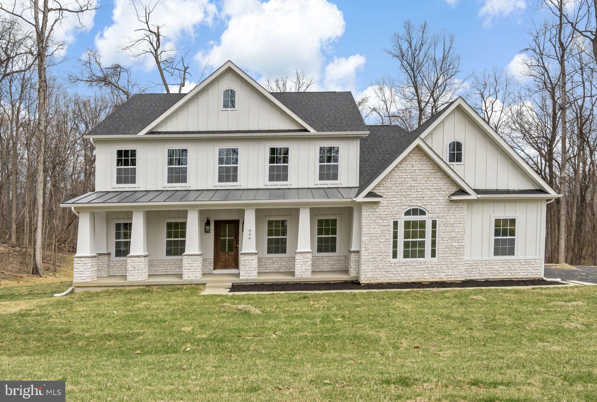 Timeless Colonial Charm Meets Modern Comfort—Move-In Ready!

Discover a perfect fusion of classic elegance and contemporary luxury in this newly constructed Colonial home, nestled on 3.94 acres of lush, wooded serenity. Offering unmatched privacy and peaceful surroundings, this refined retreat delivers the comfort of modern living without sacrificing timeless charm.

A beautifully paved driveway sets a sophisticated tone, leading to a striking Colonial façade enhanced by a full-width front porch with Craftsman-style columns—a perfect blend of traditional architecture and inviting curb appeal. Whether you're sipping morning coffee or unwinding in the evening, this charming porch offers a warm welcome and a peaceful place to relax.

Step inside to an open-concept floor plan bathed in natural light, where there are expansive windows that frame picturesque woodland views.

At the heart of the home lies a chef-inspired kitchen—complete with quartz countertops, custom cabinetry, stainless steel appliances, and a spacious center island perfect for casual dining or lively gatherings. The adjoining formal dining area and cozy family room with a fireplace create a warm and welcoming ambiance for both entertaining and everyday living.

The main-level primary suite is your personal sanctuary, featuring a spa-like en-suite bath with a soaking tub, walk-in shower, dual vanity, and generous walk-in closet. A versatile bonus room on this level is ideal for a home office, library, or playroom—tailored to your lifestyle needs.

Upstairs, three spacious bedrooms offer comfort and privacy, each with easy access to private or semi-private bathrooms—perfect for family members or guests.

Step outside onto the expansive composite deck to take in the beauty of your wooded oasis. Whether you’re hiking your private trails, hosting al fresco dinners, or simply enjoying the sounds of nature, this nearly 4-acre property invites endless outdoor enjoyment.

The fully finished garage is designed with convenience in mind, featuring two automatic openers, a pedestrian door, painted walls, finished flooring, and ample storage space.

In addition to its peaceful, secluded setting, this home is ideally located near a wealth of historical and recreational attractions. Explore nearby Civil War battlefields, hike or bike along scenic trails, or take a short drive to the vibrant towns of Harpers Ferry, Charles Town, Leesburg, and Winchester. Whether you're a history enthusiast, outdoor adventurer, or just looking to enjoy charming local destinations, you'll find something for everyone just minutes away.  

Though tucked away in nature, you’re just a short drive from top-rated schools, shopping, and everyday amenities. Whether you're looking for your forever home or a luxurious weekend escape, this Colonial masterpiece offers the best of all worlds—timeless style, modern comfort, and natural beauty.

This exceptional home is ready for you—schedule your private tour today!