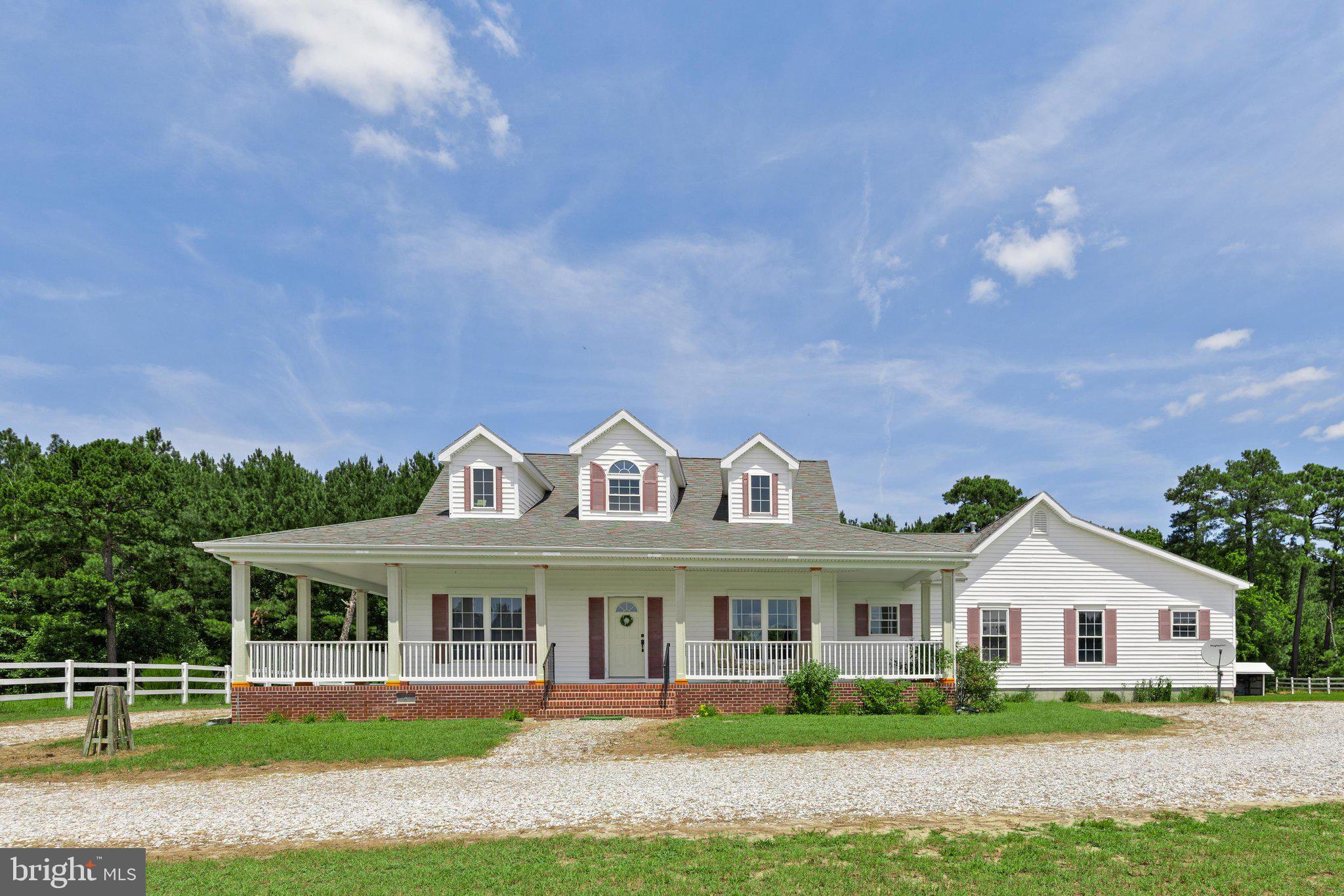 Welcome to your own private retreat on 3+ acres, where peaceful country living meets quality craftsmanship. Set back along a long driveway and backed by mature trees and fenced pastures that have previously accommodated horses, this beautifully maintained one-level Southern Coastal-style home offers the perfect blend of privacy, comfort, and versatility. Built with durable 2x6 construction, this super energy efficient 3-bedroom, 2.5-bath home features an open floor plan with vaulted ceilings, abundant natural light, and a spacious primary suite with heated floors a soaking tub and separate shower. Relax on the wide wraparound porch or gather around the cozy fireplace. The oversized insulated two-car garage includes its own propane heater, and quality touches such as solid wood interior doors reflect the exceptional craftsmanship throughout. This is a rare opportunity to own a unique property where enhanced features, country charm, and room to roam come together. A complete list of upgrades and improvements is available for interested buyers.