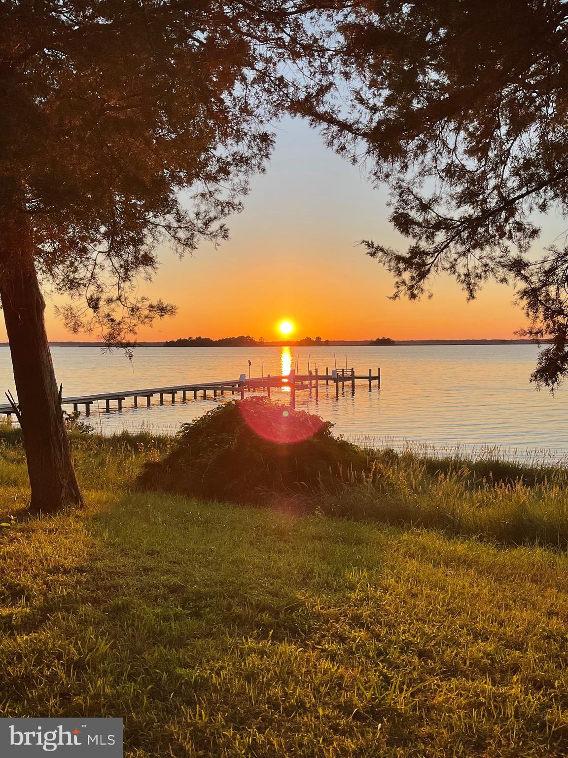 Welcome to easy living on the shores of the Wicomico River, where peaceful waterfront living meets the natural beauty of Maryland's Eastern Shore. Whether you're searching for a full-time residence, a weekend retreat, or the perfect vacation home, this property offers the ideal setting to slow down, reconnect, and enjoy everything the Chesapeake Bay lifestyle has to offer. As soon as you enter the home, your eyes are naturally drawn to the water. The spacious living room is lined with large windows that beautifully frame the peaceful river, keeping those calming views front and center. The main level also features a welcoming dining area for gathering with family and friends, a comfortable kitchen, first-floor bedroom, full bath, laundry space, and a generous storage & pantry area. Just beyond the living space is what may become your favorite room in the house—the three-season room overlooking the river. Picture mornings with a cup of coffee as the water quietly comes to life and evenings watching breathtaking sunsets paint the sky in shades of gold, pink, and orange. Outside, mature trees—including blooming mimosa and crape myrtles—create a peaceful, shaded setting that feels wonderfully private. Sandy beach frontage invites you to launch a kayak, cool off with a swim, or simply relax along the shoreline, while the fenced portion of the yard offers a secure space for children or four-legged family members to play. An outdoor shower makes rinsing off after a day on the water effortless. Upstairs, you'll find a second full bath, a flexible space perfect for a walk-in closet, office, or cozy sitting area, along with two attached bedrooms that provide a quiet place to unwind. Easy walk-in attic access offers convenient storage for seasonal décor and treasured keepsakes. Additional features include a new roof on the three-season room, and a spacious detached outbuilding perfect for storing fishing gear, lawn equipment, kayaks, paddleboards, and everything that comes with waterfront living. There's also an outdoor shower for rinsing off after a swim! Located just minutes from the Mount Vernon Harbor & Boat Ramp, you'll have easy access to fishing, crabbing, boating, and endless days exploring the Wicomico River, which flows directly into the Chesapeake Bay. When you're ready to venture beyond the river, you're only about an hour from the beaches of Ocean City, the untouched beauty of Assateague Island, and the charming coastal town of Chincoteague. If you've been dreaming of a place where life feels quieter, the views never get old, and weekends are spent on the water instead of in traffic, this is the escape you've been waiting for. Come experience the relaxed pace, stunning scenery, and unforgettable waterfront lifestyle that make Maryland's Eastern Shore such a special place to call home. Please note: Third-party websites may reflect an incorrect property tax amount. Annual property taxes are approximately $3,207.