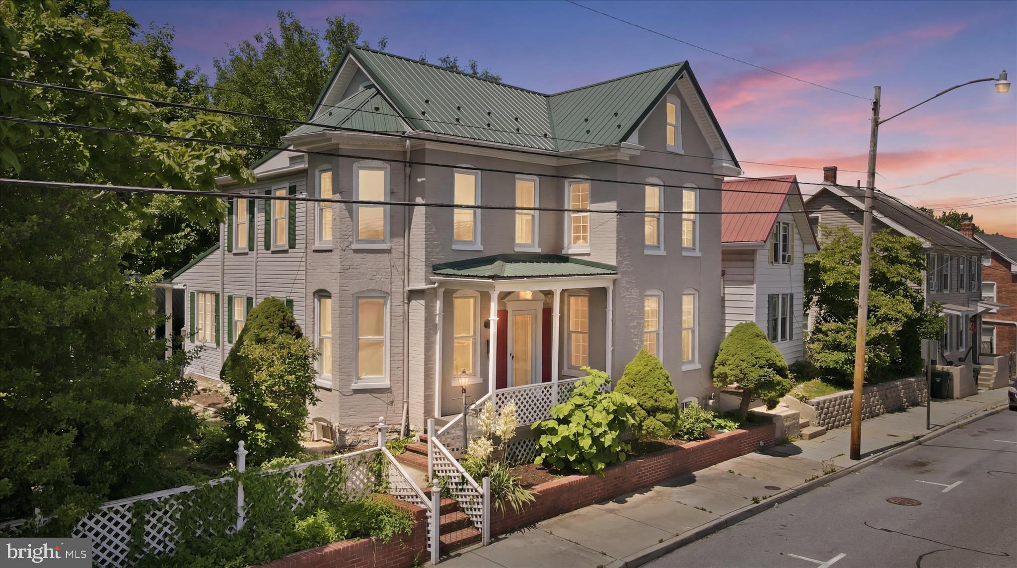 Welcome to 719 W Church Street,  a classic 1905 all-brick Colonial that has been comprehensively updated from the inside out while preserving the craftsmanship and scale that newer construction simply can't replicate. Sitting on a generous 8,856 square foot lot in Hagerstown's West End, this home offers over 2,000 square feet of thoughtfully refreshed living space across a flexible, multi-room floor plan. The layout delivers room for every need — a living room, family room, dining room, dedicated den/office, and a bright sunroom across the main level. Four bedrooms upstairs, all served by a full bath, with a convenient half bath on the main floor. A full unfinished basement adds significant storage or future finishing potential. There are 8 individually zoned mini-split units for efficient, room by room heating and cooling year round. Electrical wiring and panel upgraded to 200-amp service. Plumbing updated to current city code. New LVP flooring throughout. Renovated kitchen with granite countertops, tile backsplash, and new stainless steel appliances. Updated bathrooms with new vanities and floor. The detached 2-car garage + workshop (684 sq ft) is a rare find in this market,  whether you need serious storage, a workshop, or covered parking for multiple vehicles, this alone separates 719 W Church from everything else available at this price point. At 82x108 feet, the yard offers genuine outdoor space for gardening, entertaining, or simply room to breathe uncommon for in-city living. Location to I-81, I-70, downtown Hagerstown, Hospital, and commuter routes to Frederick and the DC metro corridor!