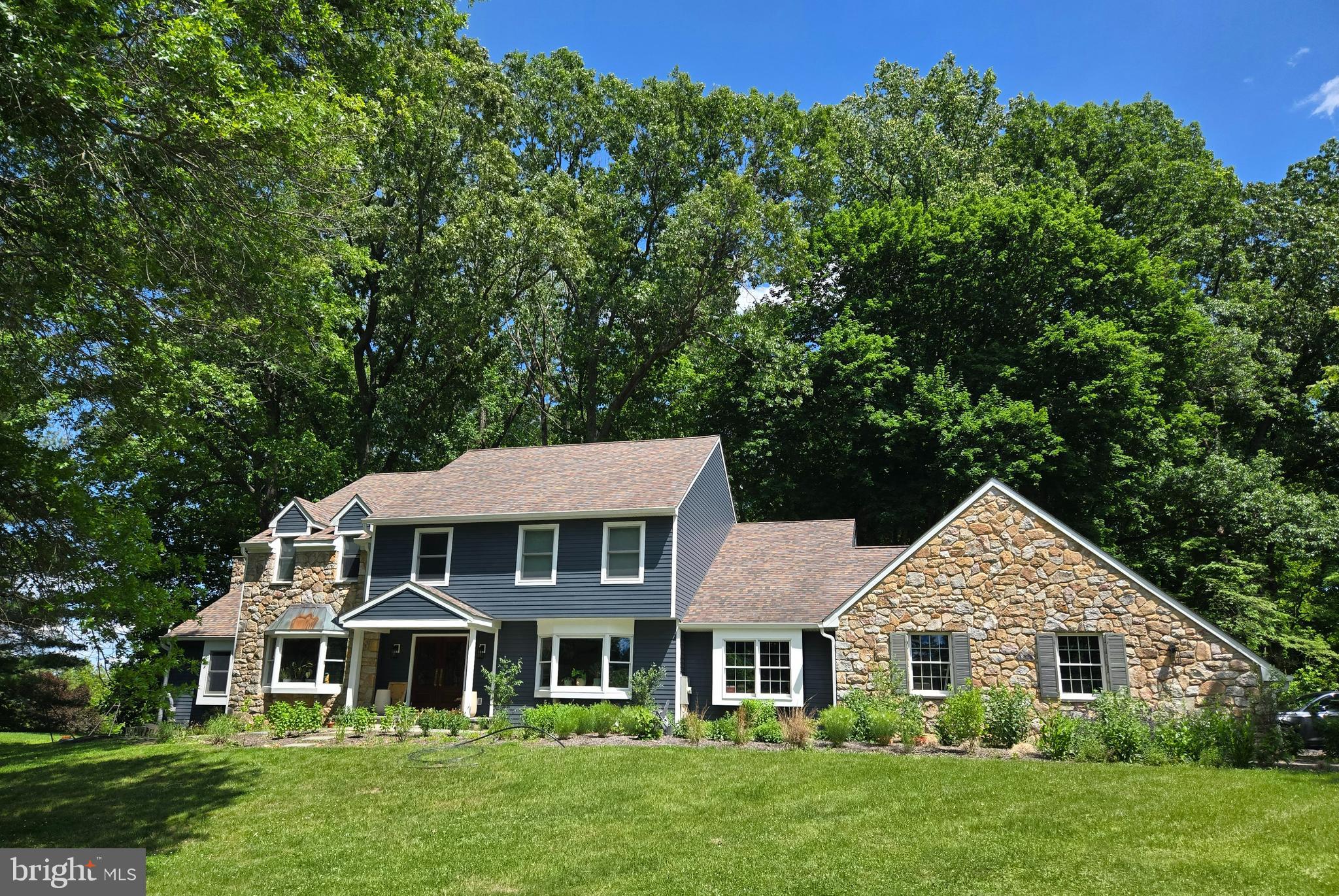 Parklike, stunning two acre setting with a pond, woods, and manicured lawns are a
natural and beautiful complement to an amazing custom built house. Only minutes from
New Hope, it is across from preserved land with a bountiful orchard. This 3500 square
foot custom built home has been steadily improved and immaculately maintained. It’s a
sophisticated yet comfortable ambiance in a storybook, private country setting. There
are specimen plantings along the flagstone front walkway that leads to the new
multipaned glass front door. Custom millwork, gleaming hardwood floors, and built-ins,
are some of the highlights. A chef’s kitchen has a center island,
plenty of cabinets, a window seat and a casual dining area. Completing the heart of this
home is a vaulted, beamed ceiling family room with gas fireplace and doors to the
private deck which wraps around the back and side of the house. A happy cook, great
conversation, and the delight of living and entertaining inside and outside. From the
kitchen is a hallway with ½ bath, laundry room, and an open but covered patio that
leads directly to the garage. Upstairs, the primary suite has a spa-like bathroom, double
sinks, skylight, jetted tub, walk-in shower, a wall of built-ins and two large walk in
closets. Three other bedrooms share a central hall bath. The office/library – a multi-purpose room - has a cathedral ceiling and a wall of bookshelves.
Many windows throughout this home bring in natural light and views of landscaping, and
changing seasons.  From the kitchen, a hallway with ½ bath, laundry room , under cover porch
leads directly to the garage. The three car garage offers plenty of storage and has been
recently fitted with beautiful new doors. And, recently the majority of the windows have
been replaced and the whole house has been redone with Everlast Composite Siding
that is under warranty that is transferable. The owners have created peaceful walking
trails throughout the woods and the native vegetation throughout
the property. If you love nature, beauty, birds and animals, quiet and serenity, and
privacy come see this amazing property. Paradise found.