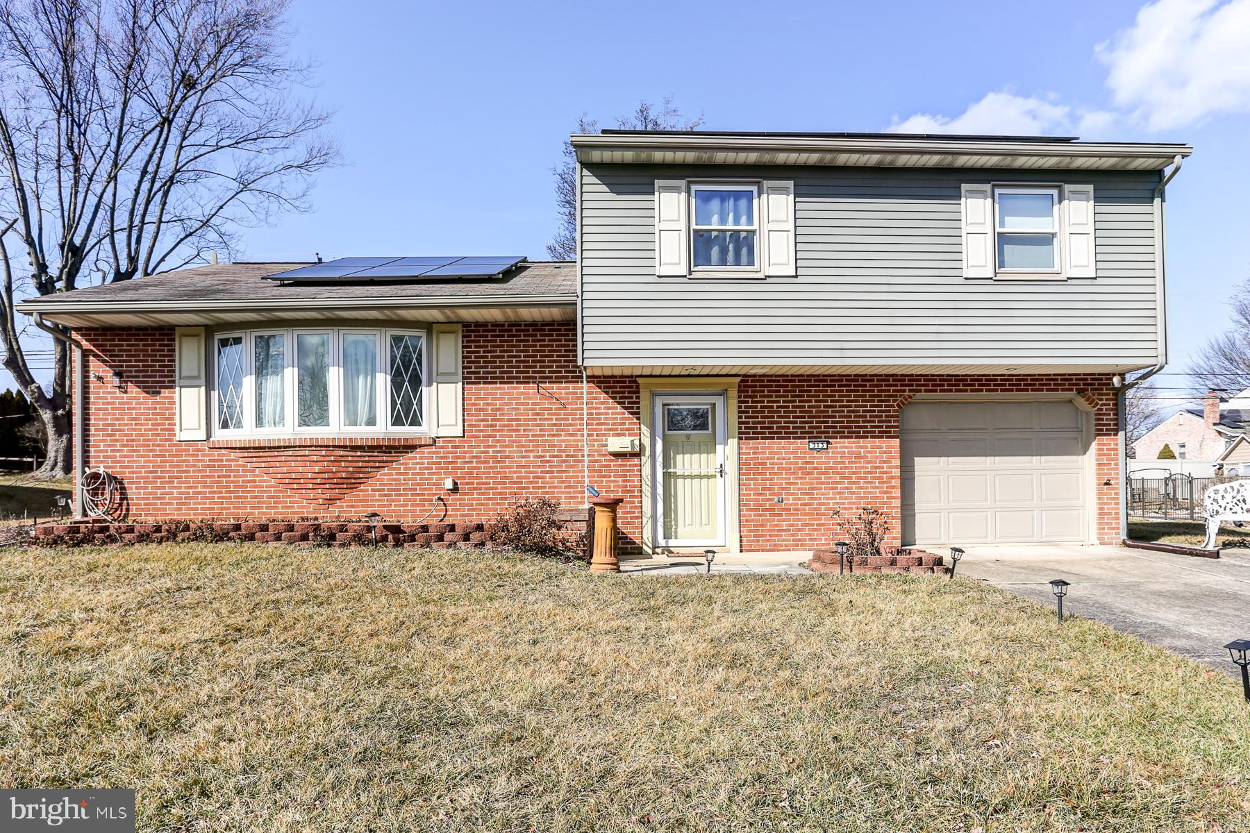 Welcome home to this move-in-ready split-level in the heart of Shiremanstown, within the sought-after Mechanicsburg School District! This spacious home features a traditional first-floor layout with a bright living room, formal dining room, and a beautifully renovated kitchen. Upstairs, you'll find three bedrooms, including a full guest bath with a tiled shower and a primary suite complete with dual closets and an ensuite full bath.  The lower levels provide even more versatile living space, starting with a spacious family room featuring a cozy fireplace and a convenient powder room. The lowest level offers additional finished space, perfect for a home office, gym, or playroom, along with laundry and ample storage.  Enjoy outdoor living on the covered rear patio overlooking the large backyard. This home is also equipped with  solar panels, offering energy efficiency.