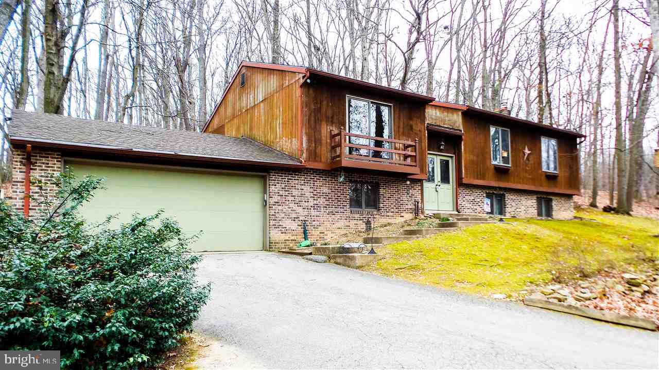 Secluded, wooded, over 1 acre lot next to a meandering stream, next to York Township park in D-town schools!  Balcony, multi-level rear secluded deck, private rear concrete patio off MBR,  4 brs, 3 bas, 1 ground level BR w/a ground level Ba - great for an in-law suite!  Rec rm w/wood stove, storage rm, new furnace, new tankless water heater, CAC, all appl incld!