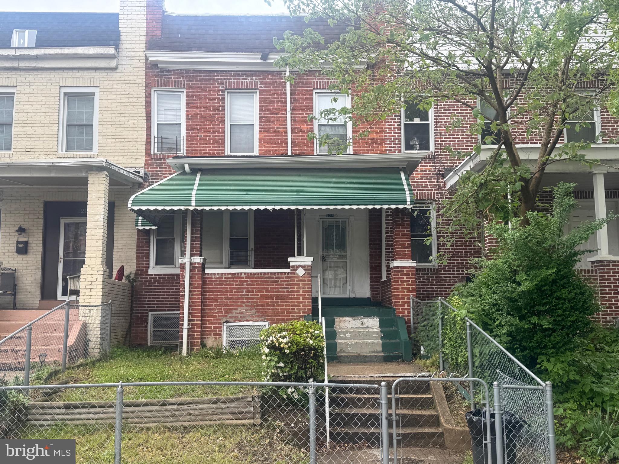 Welcome to this inviting Baltimore rowhome, featuring three bedrooms and one and a half baths. The home offers a warm, covered front porch as well as a cozy back porch, perfect for relaxing. A fenced front and back yard surrounds the home, and with a simple fence adjustment, the back could also serve as a driveway. Inside, the layout is flexible, with three well-sized bedrooms and a convenient half bath on the main floor. While the home carries some original charm, it offers fantastic potential for you to personalize and make it your own. Come see how this home can be your next welcoming retreat!