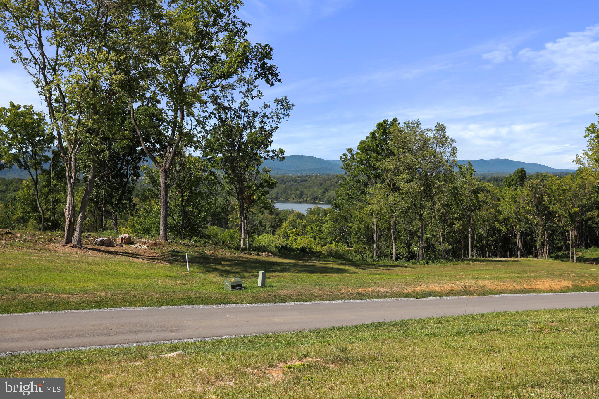 **Virtual house picture is for visual purposes only – not included in price.**
Welcome to Bella Vista Subdivision, Falling Waters beautiful, exclusive gated community, home to 12 gorgeous large lots of which no two are the same. Fall in love around every turn with sweeping mountain views, river overlooks, mature trees and the HOA's peaceful deep river access lot. Lot 25 has it all... amazing views of the mountains and river from the highest elevation in the neighborhood, flat yard, great lot for a walk out basement, private/flat side yard for a large accessory building and access in the rear of the lot to the low water section of the river via pedestrian easement. Schedule a showing today!
