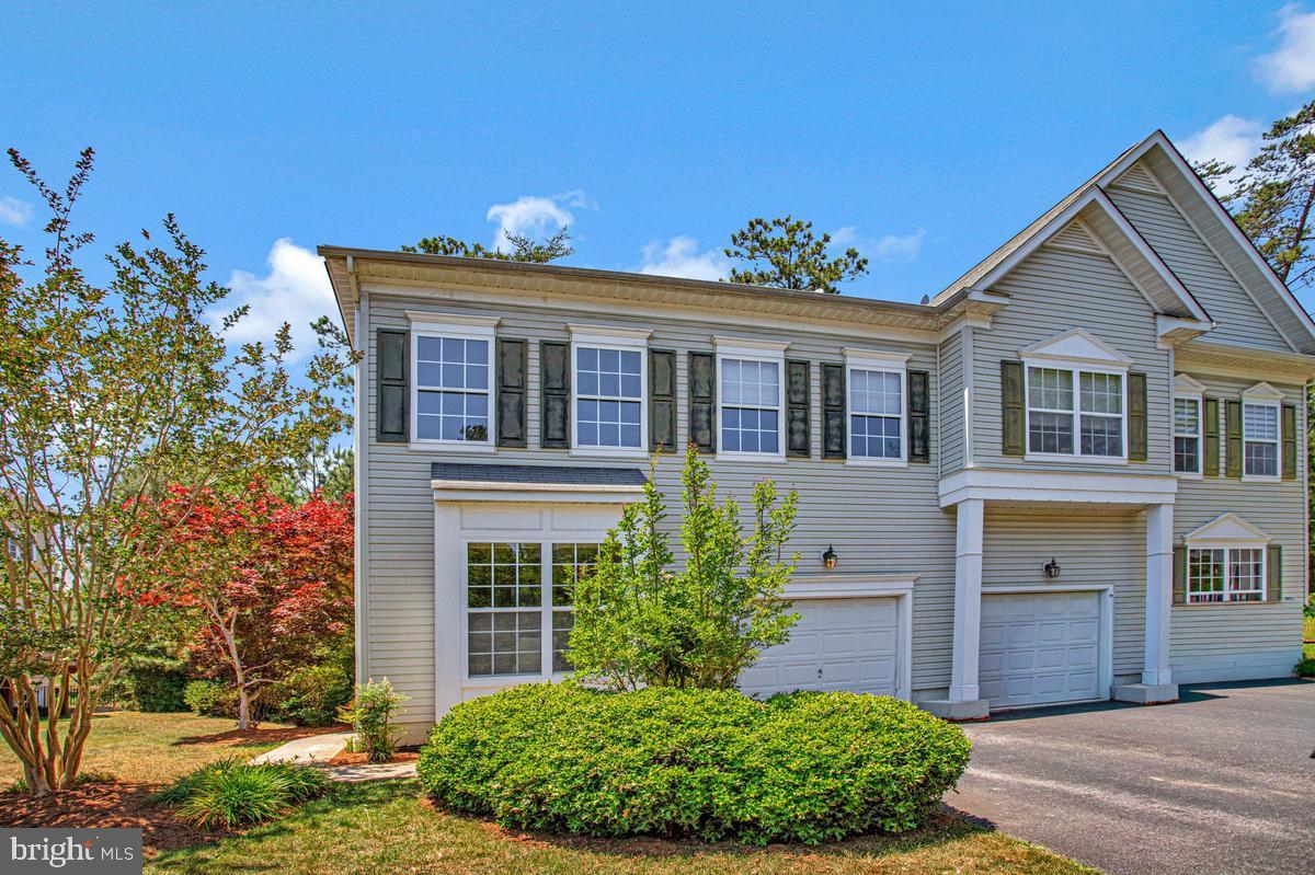 Lovely End Unit Dahlia Park Duet! 3BR/3.5 Baths. Light and Bright with a large side yard and pretty rooms throughout.  Formal separate Living Room/Office and Dining Room and a gracious light-filled entry Foyer greet you from the door.  Open Concept Gourmet Kitchen w/ island seating and pretty dining area w/ bay window. Pantry, 42' cabinets and solid surface counter tops. Hardwood flooring gleams in Family Room with gas fireplace. Upstairs the primary suite is expansive with a vaulted ceiling and 2 separate walk-in closets. The Primary bathroom has a long luxurious soaking tub, dual vanity, private WC and separate shower. 2 additional spacious bedrooms are upstairs and full hall bath. Basement is fully finished with a recreation room, storage closets, a full bath and an extra room w/ exit door to back yard.  This unit has a nice side yard and backs to trees. Add a deck and/patio and your serene retreat will be complete!  1-car front load garage and good additional street parking on Aster Way. Tour this pretty home today!