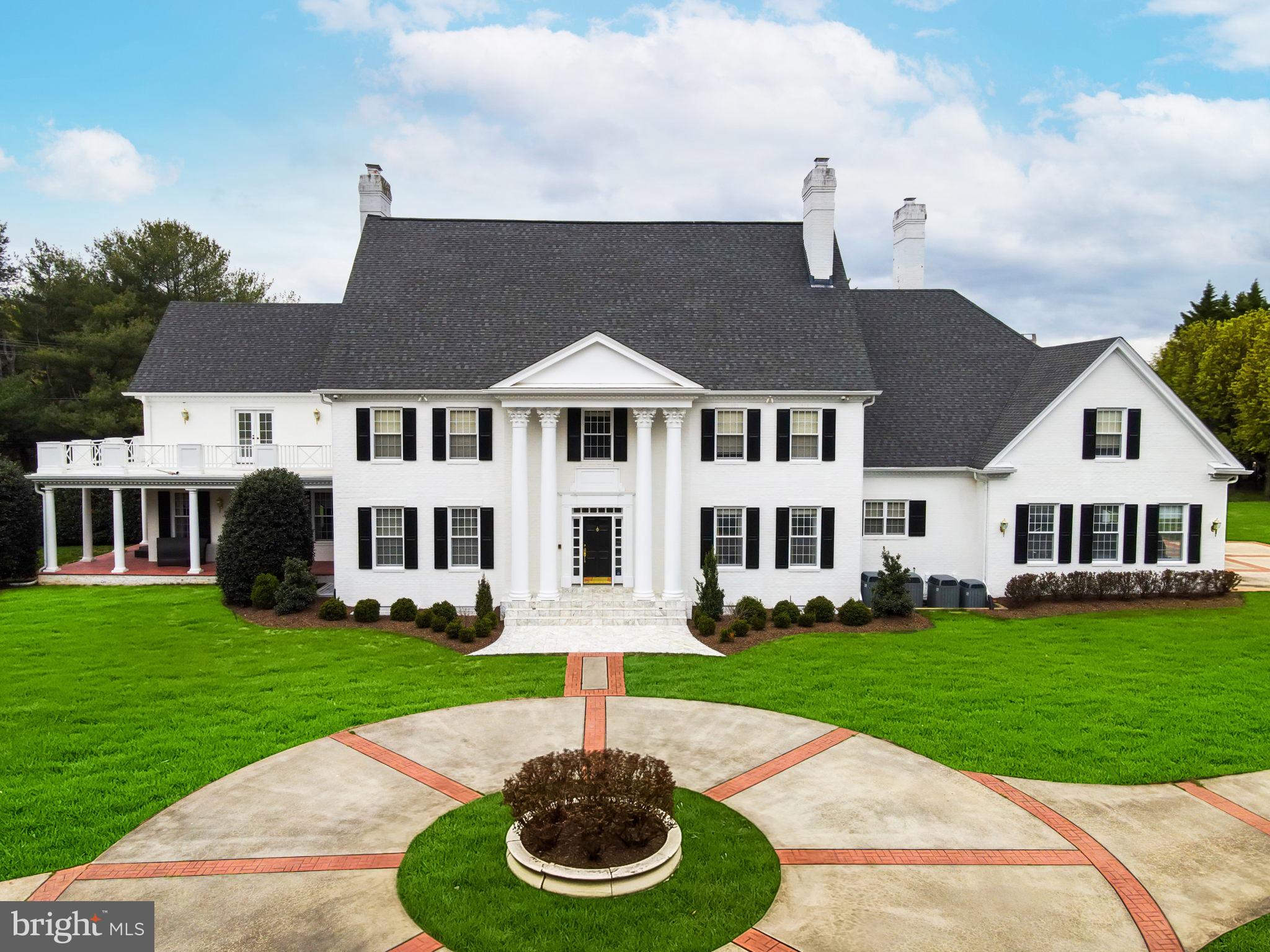 An updated private estate in the heart of Potomac’s. Built by award-winning Crowell and Baker, this custom colonial compound is the architectural masterpiece you’ve been dreaming of. Step into the
elegant two-story marble foyer adorned with matching Schonbek crystal chandeliers, intricate millwork and 270-degree gallery views. Natural light streams in through the oversized windows and doors with east/west exposure and the 10 foot ceilings emphasize the unprecedented grandeur of this home. Rich hardwood floors in a herringbone pattern provide the perfect base for traditional or modern décor in the main living areas of this meticulously maintained abode. Designed for both formal entertaining and casual living, the opulent formal dining room, family room and formal living room all feature wood-burning
fireplaces surrounded by marble, ornate moldings and custom built-in shelving. The family
room offers a wet bar with outdoor views and access. Walk down the hall through the French doors to the private wood-paneled library with views of the beautifully landscaped grounds. The expansive kitchen was updated in 2021 It has a walk-in pantry and a butler’s pantry with second dishwasher. The adjoining breakfast room with Schonbek crystal chandelier, wood-burning fireplace, built-ins and backyard access offers a modern complement to the stately home. Two marble powder rooms, a mudroom and concealed laundry room complete the main level. Take either of the two staircases to the thoughtfully designed upper level which showcases two primary suites. The largest primary bedroom has balcony access, a fireplace and three large walk-in closets. The chic en-suite bathroom was completely renovated in 2022 with dual vanities, sizeable glass shower, soaking tub. The second primary bedroom/in-law suite has a sitting room, spacious walk-in closet and en-suite bath with dual vanities. Scenic views and sunlight pour in through the windows of the four generously sized secondary bedrooms. On the lower level, the open floor plan offers a full footprint consisting of recreation space, a dedicated fitness area, wet bar, wine cellar, sauna, room with full bath and ample storage space. The raised basement affords plenty of natural light.  Your outdoor oasis is the perfect place to unwind by the heated pool with automatic cover. You can entertain in the pool house with wet bar and full bath or under one of the backyard pergolas. Extensive landscaping, patios and walkways ensure this is an outdoor space everyone will love. Ideal 2 acre property situated on a flat corner lot with circular driveway, 3 car side load garage and secure gated entry. Less than 1 mile to Potomac Village shops, restaurants and grocers.  Easy access to DC, I-495, 270 and 95.