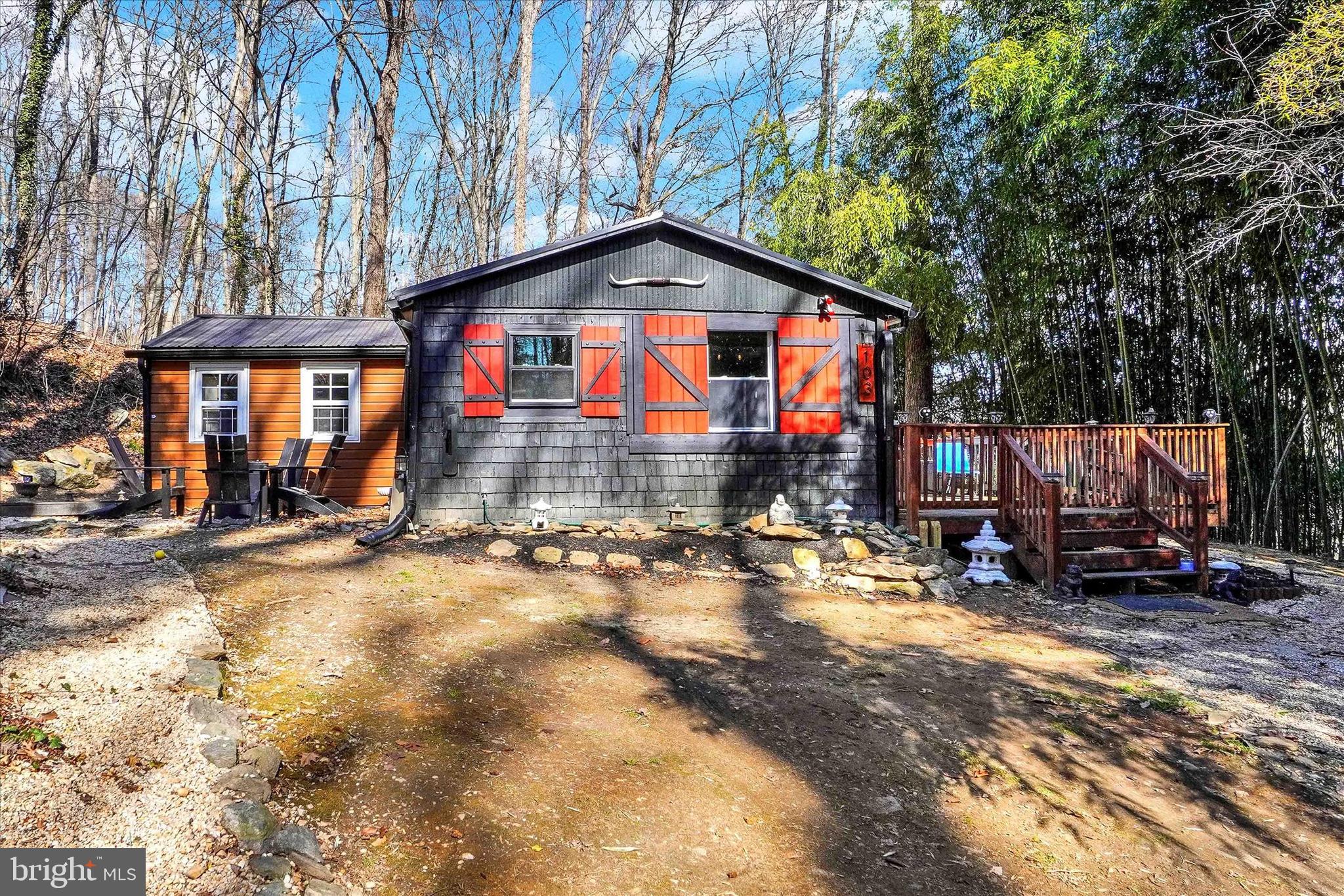 Welcome to your serene retreat nestled in a picturesque rural setting, walking trails and fishing streams! This very cool, renovated, charming 1 story, 2-bedroom, 1-bathroom cabin-style home offers a warm and inviting atmosphere with its combination kitchen/dining area, perfect for cozy gatherings. The family room, fully furnished, open with a vaulted ceiling, conveniently located off the kitchen, enhances the home's welcoming feel. Primary bedroom with a sliding glass door to the back porch.  Enjoy the beauty of nature from your OVERSIZED deck, surrounded by nearly an acre of private land featuring a Koi Pond, Fire pit, bamboo and wooded mature trees providing a tranquil escape, and creating a secluded oasis where you can unwind and connect with nature. With its rural location, you’ll relish the peace and quiet while still being just minutes to Maryland, and a short drive from local amenities. The home boasts durable luxury vinyl plank and wood flooring, adding to its rustic charm. New metal roof and new woodstove!  Updated 200+amp electric service, with an outlet for a new oven in the kitchen and an outside outlet for a generator.  All new plumbing, with a water line in the kitchen for a dishwasher.  Whether you are looking for a place to call your home away from home or your little piece of heaven, this property is ready for you to make it your own. Embrace the opportunity to live in harmony with nature in this delightful home!