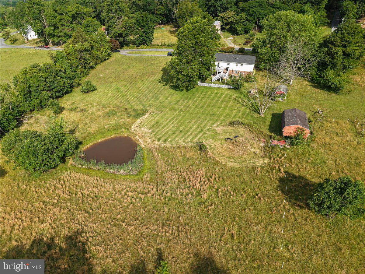 Escape to your own private slice of Shenandoah Valley paradise with this stunning 5-bedroom, 3-bathroom home set on 3.6 scenic acres in beautiful Rockingham County. Surrounded by jaw-dropping mountain views and featuring a private stocked fishing pond, this one-of-a-kind property offers the peaceful lifestyle you’ve been dreaming of — all just minutes from town, Merck, Miller-Coors, shopping, dining, and more.
From the moment you step inside, you’ll appreciate the exceptional craftsmanship and attention to detail throughout. Elegant woodwork, custom moldings, wainscoting, and stunning shiplap ceilings create warmth and character rarely found in today’s homes. The spacious layout offers room for everyone with multiple living areas, cozy fireplaces, and a finished basement den perfect for entertaining, relaxing, or multi-generational living. The property also features abundant storage and workspace options, including a utility room with washer and dryer plus two detached buildings (16x30 and 10x16), both equipped with electricity — ideal for workshops, hobbies, equipment storage, or additional flex space. Enjoy the freedom and privacy your family deserves with NO HOA restrictions. Bring your fishing rod, enjoy the peaceful setting, and plant your roots in this extraordinary property where country charm meets everyday convenience.
📍20448 Mount Pleasant Rd, Elkton, VA 22827