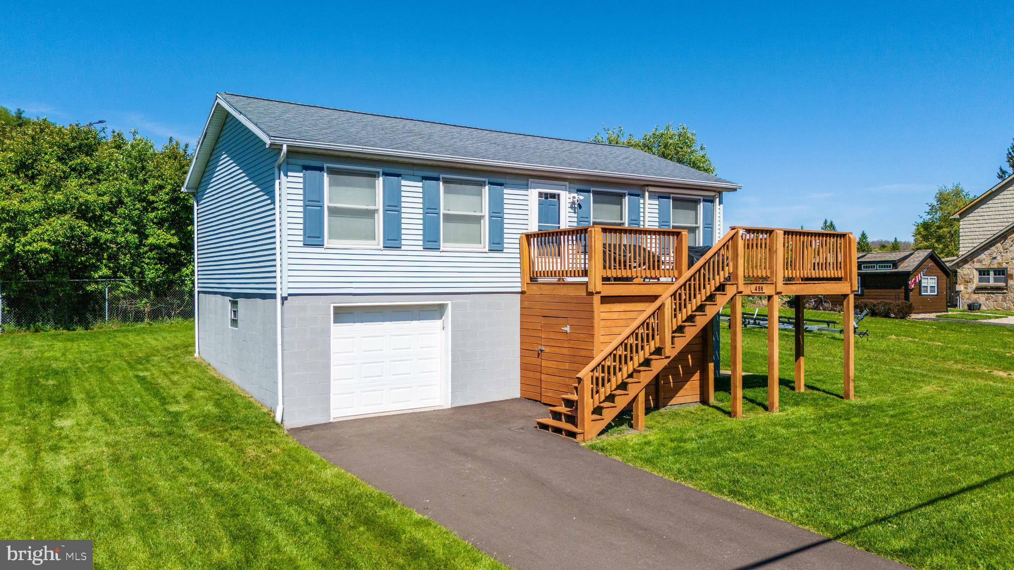 Recently remodeled! Clean and well-cared for 3BR 2BA with attached garage stall, Deep Creek Lake views AND ski slope views! You cannot get any closer to Wisp Ski & Golf resort than having your backyard share a fence - offering a FRONT ROW seat for the 4th of July fireworks! Recent additions include an additional bedroom and bathroom in lower level, updated kitchen, LVT flooring throughout, asphalt driveway, sun-setter awning, extended front deck and added a covered back porch. Public water & sewer. Partially fenced backyard. Perfect full time residence or vacation property.  Sold mostly furnished. NO HOA!