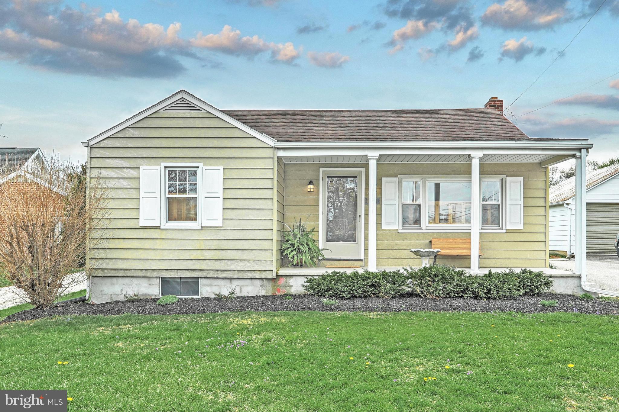 Welcome home to this professionally remodeled cottage cape styled rancher.  Enjoy the view from the front porch that leads to a large living room with a picture window and hardwood flooring.  Eat-in kitchen with luxury vinyl tile flooring, new countertop and stainless stove.  Updated lighting.  2 bedrooms with hardwood flooring and ceiling fans.  Remodeled bath with barn door, new vanity, luxury vinyl tile flooring and tiled tub/shower.  Coat closet.  Walk-up attic storage complete with blown-in insulation and attic fan.  Lower level was dry-locked.  Family room space is framed out with carpeting, 2 storage rooms, and laundry area with sink and shower.  Outside fireplace and workshop with concrete floor, woodstove, electric, workbench, and covered side porch for outside enjoyment.  Sliding door to the rear opens to even more yard space.  Lovely X-large level lot.  Home is ready for a new homeowner - just move right in!