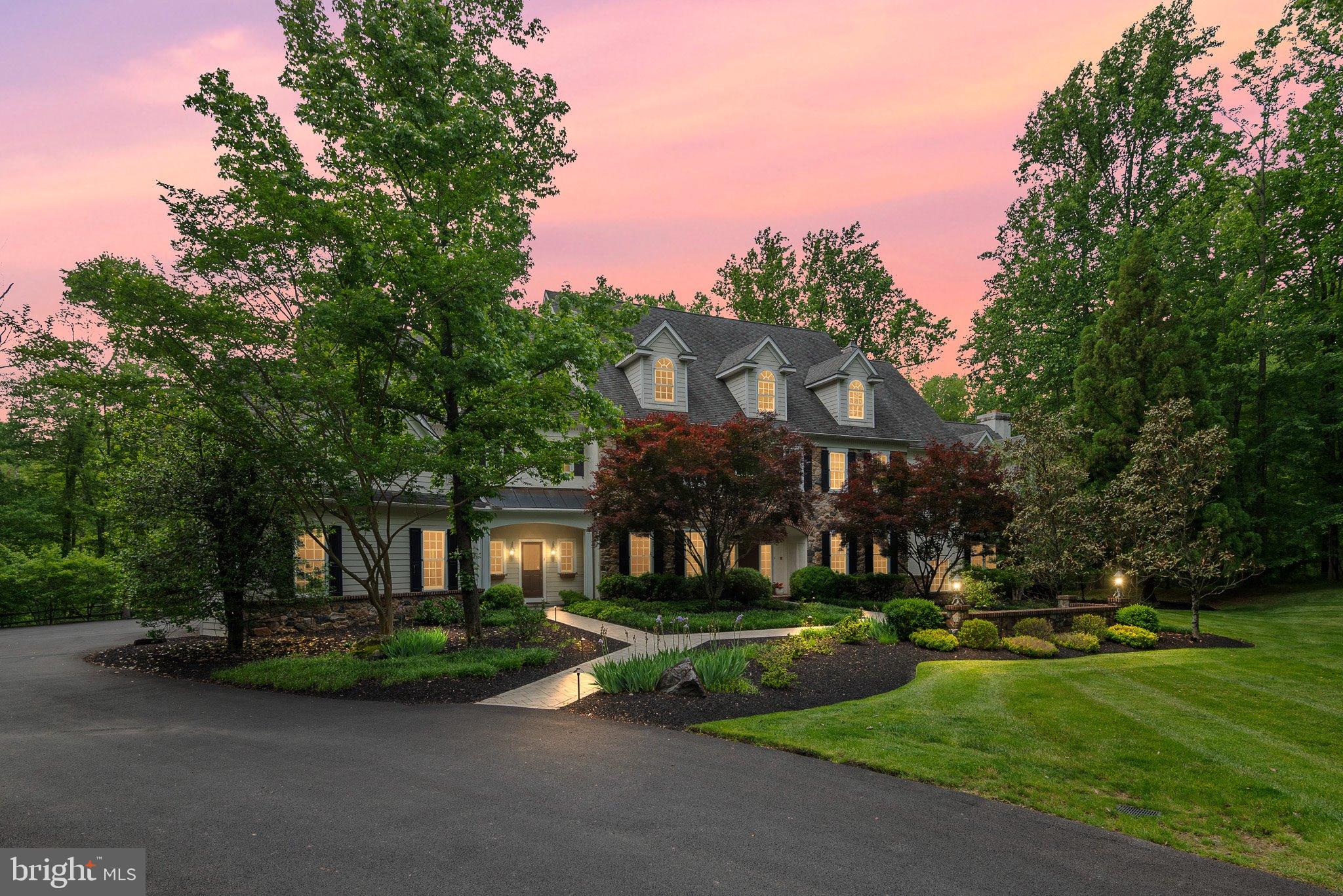 Welcome to 104 Timber Ridge Lane, an exceptional modern manor set on 3.5 private, wooded acres in the heart of Chadds Ford, Pennsylvania. Offering more than 8,383, square feet of above grade refined living space, this residence blends timeless architectural detail with luxurious modern amenities. A grand foyer introduces the home, framed by elegant arches that lead to the formal living room with a fireplace on one side and the sophisticated dining room on the other. The dining room features a full‑size bar and butler’s pantry, creating an ideal setting for entertaining. A custom iron gate opens into the gourmet kitchen, appointed with top‑tier stainless steel appliances, granite countertops, custom cabinetry, and a tiered island. The adjoining breakfast room, bathed in natural light, opens to the expansive cedar deck through wall‑sized French doors. The open layout flows seamlessly into the family room, highlighted by a deep coffered ceiling and a striking stone fireplace. The main level also includes a private office, two powder rooms, a mudroom, and access to the 4‑car garage. Throughout the home, reclaimed chestnut and variable‑width hardwood floors add warmth, character, and a sense of history. The upper level offer five spacious bedrooms, each with en‑suite bathrooms, along with flexible spaces perfect for playroom, offices, hobby rooms, studios, or additional family rooms. The luxurious primary suite features two fireplaces, a spa‑inspired bath, and dual walk‑in closets. The fully finished lower level is designed for recreation and relaxation. Enjoy a home theater, game room, fitness room, wine cellar, wet bar, and a private guest suite with a full bath. Walk out to the slate patio and take in the sweeping lawns and surrounding woodlands. Outdoors, the expansive deck and barbecue area overlook the rear grounds, offering serene views and abundant space for gatherings. With its grand scale, thoughtful design, and unmatched privacy, 104 Timber Ridge Lane presents a rare opportunity to experience luxury living in one of Chadds Ford’s most picturesque settings.