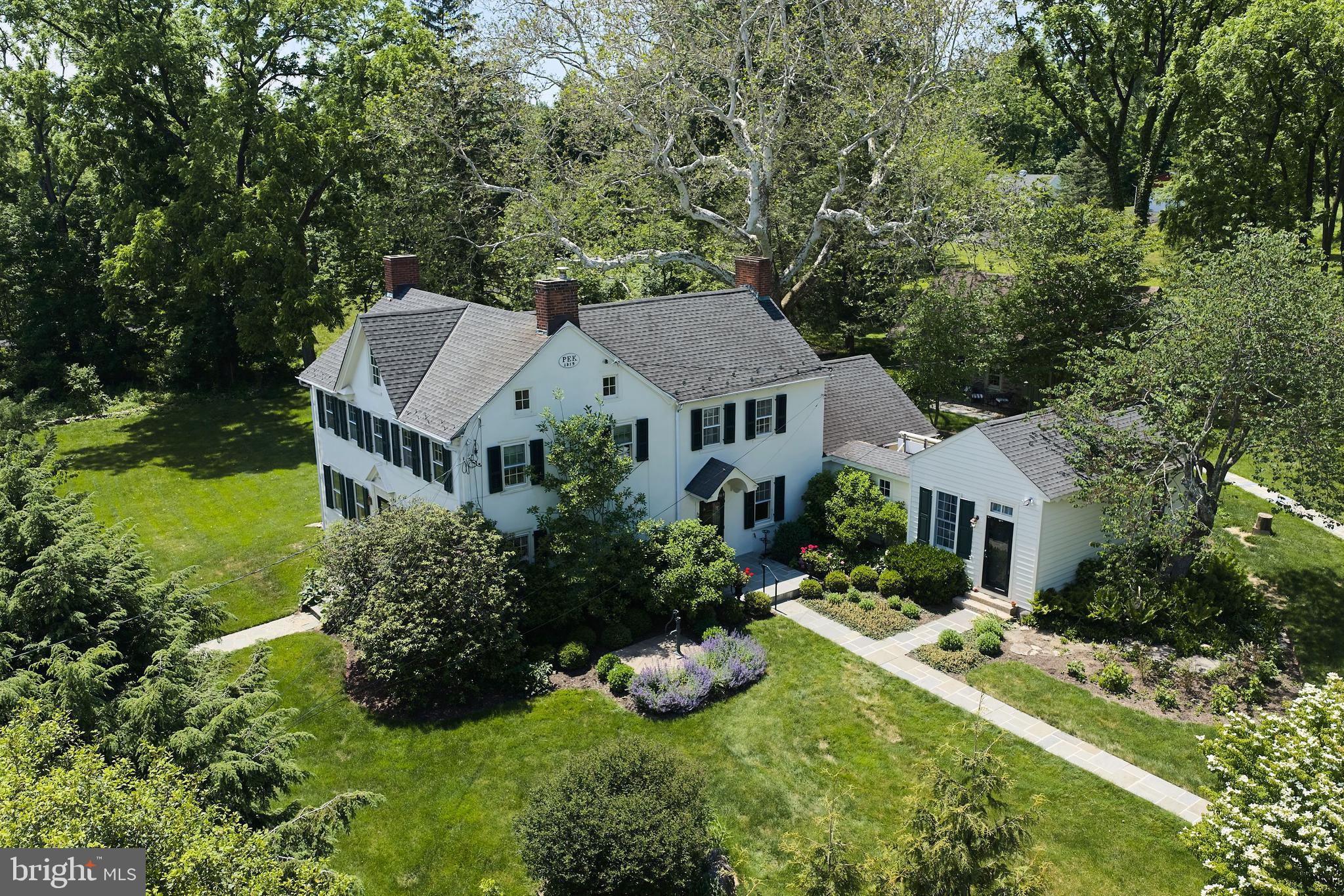 Bucks County Gentleman's Stone Farmhouse and Cottage - FLOWERS ARE POPPIN.-TIME TO STOP IN!!   This charming 1819 stucco-over-stone home has been lovingly maintained and improved for over 200 years.   The modern updates make this home a wonderful setting for multi-generational living, a growing family, pied-a-terre with  rental income a bonus.   The main house features a first-floor master suite in a private wing. The second floor has two bedrooms and an office/bedroom.  The larger of the two has a fireplace.  The second master suite has an ensuite bath, open beamed ceiling, and fireplace with built-in closet space on either side.  The main living room has built-in bookcases and storage with book-end fireplaces, open beams, and the original front door and lock.  The keeping room is pine paneled with an open beamed ceiling and a fireplace to warm your guests on a winter evening.    The hub of the home is the remodeled kitchen and inviting sunroom featuring two walls of windows, radiant heat floor, and a 13-foot maple island to keep the chef in the middle of every gathering.    The home has central air, a waterproofed 
basement,  updated electrical, and two sumps with battery backup.   Topside is a walk up attic offering possibilities for expansion.
     In addition to the gracious living space of the main house, there is a two-bedroom stone cottage for extended family, guests, or rental income.   It is believed that the cottage predates the main house, with very wide, gleaming pumpkin pine floors, open beams, and deep-silled windows.   It has a kitchenette,
bathroom with heated floor, washer and dryer, and its own secluded patio.   The second floor has a small second bedroom /office space, with walk-up access to the attic adding even more of storage.
     The Studio is tucked away inside the old, reinforced stone walls of the barn, lost to the ages.  With twin French doors facing south for plenty of light making it a wonderful space for hobbies and a French door opening to a patio tucked in a quiet place for meditation.  The metal roof is insulated, the exterior is hardy plank and the interior is ready for your unique touches.
     Can't beat the location.... next door is a door bucolic pasture with grazing sheep and llama.  Only 5 minutes down the road is Doylestown to the south and Plumsteadville to the north with wonderful restaurants, retail, entertainment, museums and services.   Country living with city convenience!
     New Hope and Lambertville are under 20 minutes and Peddlers Village is 10 minutes.   Commutes to multiple airports, trains and buses to make commutes to New York, Philadelphia and the Lehigh Valley manageable.   Here is your chance to get out of the rat race!   Owner is a licensed PA/NJ RE agent.