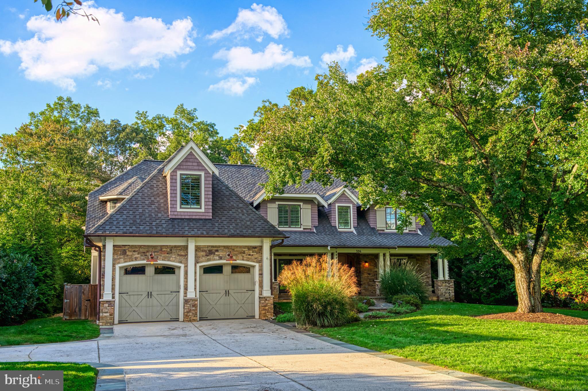 Stunning Custom Home on Coveted Druid Hill Road! 
This exceptional custom-built home offers unmatched craftsmanship and thoughtful details rarely found in newer constructions. A slate paver front porch with a wood-paneled ceiling welcomes guests, leading to a striking Andean walnut front door. Inside, rich hickory flooring, coffered wood beams, and a wall of windows in the family room create an immediate “wow” factor with stunning views of the backyard.

The open foyer leads to the elegant dining room, where French doors open to the front porch, seamlessly blending indoor and outdoor entertaining. The heart of the home is the open-concept living space, featuring a gourmet kitchen with custom cherry cabinetry, a double island, built-in refrigerator drawers, and a hammered copper sink in the coffee bar. A charming octagonal breakfast nook offers panoramic views of the backyard.

A private home library sits just off the main entrance. The family room flows effortlessly onto a spacious deck and a cozy screened-in porch, perfect for enjoying the seasons. This level also includes a walk-in pantry with a Dutch door, a large laundry room, and a back hallway with built-in cubbies for easy organization. A full bathroom and an additional home office or sunlit bedroom provide versatility and privacy.

Upstairs, a spacious loft offers the perfect gaming or homework space. Each bedroom has its own attached bathroom, walk-in closet, and unique architectural details such as eaves and nooks. Bedroom #2 features two rooms connected by a custom-tiled Jack-and-Jill bathroom leading to Bedroom #3, which boasts a grand window and an oversized closet. Bedroom #4 is ensuite with a beautifully designed rustic-tiled bath. The luxurious primary suite includes two oversized walk-in closets with built-ins and a laundry hookup. The spa-like primary bathroom features heated floors, dual vanities, a soaking tub overlooking the backyard, and a glass-enclosed shower.

The daylight-filled lower level is designed for entertaining, featuring a large recreation room with a stone fireplace, a 100-inch projection screen with surround sound, and space for a future full bar. French doors open to a covered patio making this an ideal space for hosting Super Bowl parties or movie nights. This level also includes an additional bedroom, full bathroom, exercise area, and a spacious workshop with 120V and 240V pre-wiring and a private entrance.

The professionally designed, flat, partially fenced backyard is perfect for soccer, volleyball, or a future pool. A charming storage shed sits in the back corner, and the expansive deck constructed with Geodeck offers a low-maintenance outdoor retreat.

Living in the Town of Vienna comes with incredible benefits, including trash pickup, snow removal, and priority access to Parks & Recreation programs. Enjoy community events such as the annual Halloween Parade, Oktoberfest, summer concerts, and ViVa Vienna. The home is conveniently located less than a mile from Starbucks, Giant, Fresh Market, and local dining. Wolftrap Elementary is just a short 0.6-mile walk, and the W&OD Trail, downtown Vienna, and Wolf Trap National Park for the Performing Arts are all within minutes.

This home is a rare find—where quality craftsmanship, modern amenities, and a prime location come together to create the perfect place to call home. Open Houses: Sat., 02/22 2-4 pm and Sun., 02/23 1-3pm