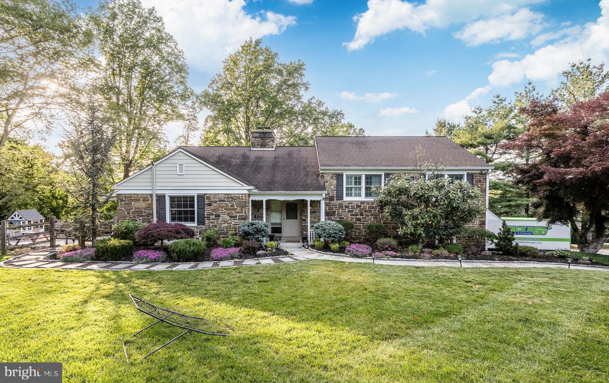 Welcome to 1708 Riverview Road — a beautiful home with many updates and amenities. This bright, sunny, spacious stone split-level home sits on over .76 acres in a wonderful neighborhood on a lovely street in Gladwyne.

The kitchen is large and eat-in, featuring stainless steel appliances, granite countertops, an island with stools, limestone floors, generous cabinet and storage space, double ovens, a tile backsplash, and an undermount sink. A door leads directly to a patio and outdoor space — perfect for enjoying meals or relaxing outside.

The Living Room and Dining Room combination features hardwood floors, a brick fireplace, and large picture windows that flood the space with natural light and sunshine.

A half flight down you will find a spacious Laundry Room with washer, dryer, laundry sink, and newer cabinets and countertops — ideal for storage and folding laundry. Across the hall is a very large storage closet with shelves and cabinets. You can also enter through the renovated 2-car Garage, which offers additional storage space. The home also features a newer HVAC system and a new septic system, giving you peace of mind for years to come.

The second level features a Primary Bedroom with a walk-in closet and an updated primary Bathroom, along with two additional bedrooms and a lovely hall Bathroom with a large closet. All bedrooms on this level have ceiling fans.

The top level offers a huge bedroom with great closet space, a ceiling fan, and an additional storage closet. The attic is floored, has a window, and provides even more storage space.

The lower level is above ground and beautifully finished, complete with a full bathroom. With two separate areas, this flexible space can serve as a Guest Suite, Family Room, Playroom, Gym, or Office — or more than one at the same time. An entire wall of built-ins provides ample storage, and an outside door opens directly to the grounds.

Upgrades include:
Siding and downspouts 2016-2017
French drains, sump pump and water proofed basement 2018
Hot water heater 2019
All windows replaced 2015-2016
Propane run generator 2021
Entire property landscaped and rear yard leveled for large play area
Removal of many trees and tree stumps
New Septic System 2023
framed/insulated walls in garage 2022
buried electric cable 2022
HVAC replacement 2023

Enjoy this beautiful home in the award-winning Lower Merion School District, conveniently located close to major highways, shopping, libraries, Center City, and King of Prussia.