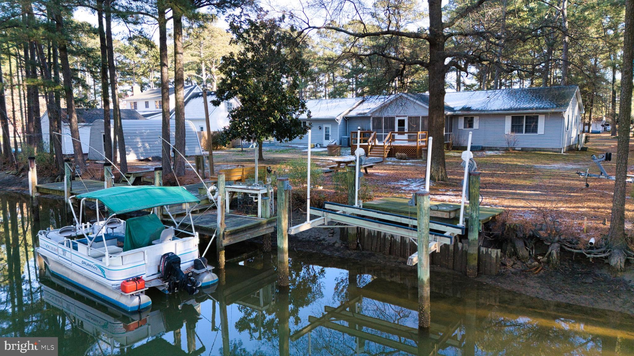 Motivated Sellers, receptive to all reasonable offers! Welcome to this brand-new listing in the Annamessick Ridge Community of Crisfield! This adorable three-bedroom, two-bath home is a true custom coastal charmer. Enjoy a private dock complete with a boat lift and a fishing-clean station, making it easy to head out on the water anytime. A community boat ramp for added convenience. This home is all about embracing the waterfront lifestyle and enjoying everything this fantastic location has to offer. 
Inside, the kitchen showcases classic Crisfield crab charm, featuring quartz countertops and ample storage. A living/dining area is located just off the kitchen and overlooks the back enclosed porch, creating a comfortable flow for everyday living and entertaining. The home also offers a separate dining room and a dedicated living room, providing flexible spaces to relax and gather.
Perfectly positioned to take on the waterways and enjoy everything this home’s location has to offer, this property delivers the laid-back coastal lifestyle of the Eastern Shore.