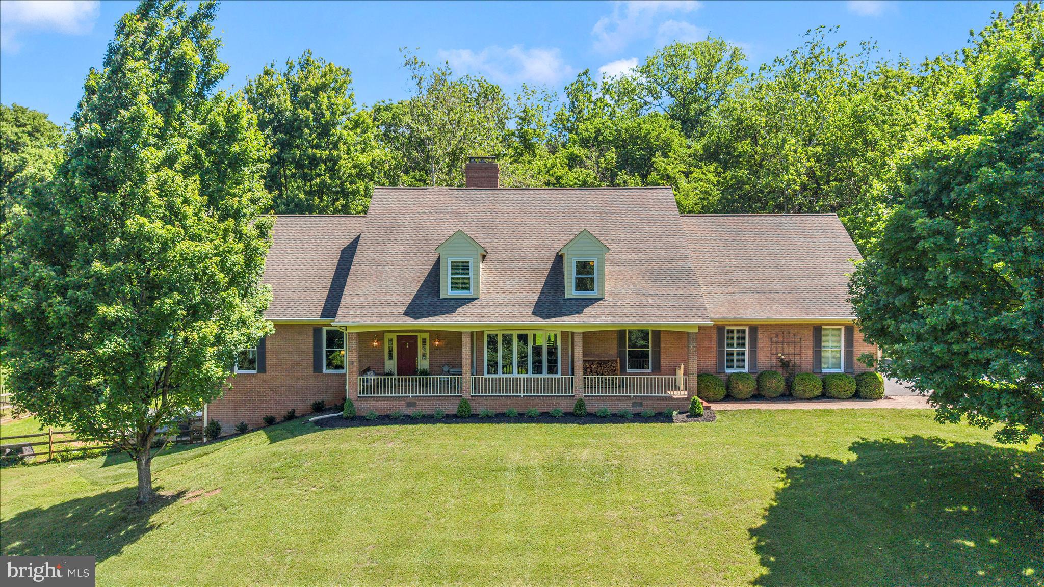 Custom built by Ausherman Builders, this stately all-brick estate offers the perfect blend of quality craftsmanship, generous living spaces and features, all with a sense of privacy. From the moment you step into the foyer, you'll appreciate the home's thoughtful design, impressive scale, and inviting atmosphere.  The main level features expansive rooms throughout, including a formal family room, elegant dining room, and a spacious living room centered around a cozy fireplace. A convenient main-level bedroom and full bath provide flexibility for guests.  Filled with natural light, the beautifully updated kitchen serves as the heart of the home, featuring new flooring, backsplash, and an open-concept layout that flows seamlessly into the breakfast area, where a pellet stove creates the perfect setting for relaxed mornings and intimate gatherings.  Designed for everyday convenience, the home also offers a mudroom with abundant storage, an oversized laundry room with custom cabinetry, and a main-level powder room.  Upstairs, you'll find 5 additional spacious bedrooms and 3 bathrooms.  The owners' suite includes a newly remodeled bathroom.  The fully finished walkout lower level expands your living and entertaining options with an additional family room featuring a pellet stove, a bonus room, full bath, workshop, and extensive storage space.  Step outside to your own private resort-style retreat. The backyard showcases a beautiful Gunite pool, a fountain, greenhouse, thriving vegetable garden, potting station, spacious patio, and additional storage beneath the porch—creating an outdoor oasis ideal for entertaining, gardening, or simply enjoying the peaceful surroundings.   Beyond its impressive living spaces and resort-style outdoor amenities, this home has been meticulously maintained and thoughtfully updated. Recent improvements include a new water heater in 2024, replacement well pump in 2018, 23 upgraded windows and a repaved driveway in 2013, as well as HVAC systems replaced in 2022 and 2014 with continuous maintenance contracts. The fireplaces, HVAC systems, and water treatment equipment have received consistent annual maintenance, while the septic system has been recently serviced. A 12.5 kW Generac whole-house generator with transfer switch further enhances the home's comfort, reliability, and peace of mind.   Offering remarkable space, enduring quality, and an unparalleled outdoor setting, this distinguished estate presents a rare opportunity to enjoy luxury living in a truly spectacular location.   No HOA and Middletown Schools!  Timeless Elegance, Exceptional Space & Breathtaking Views!