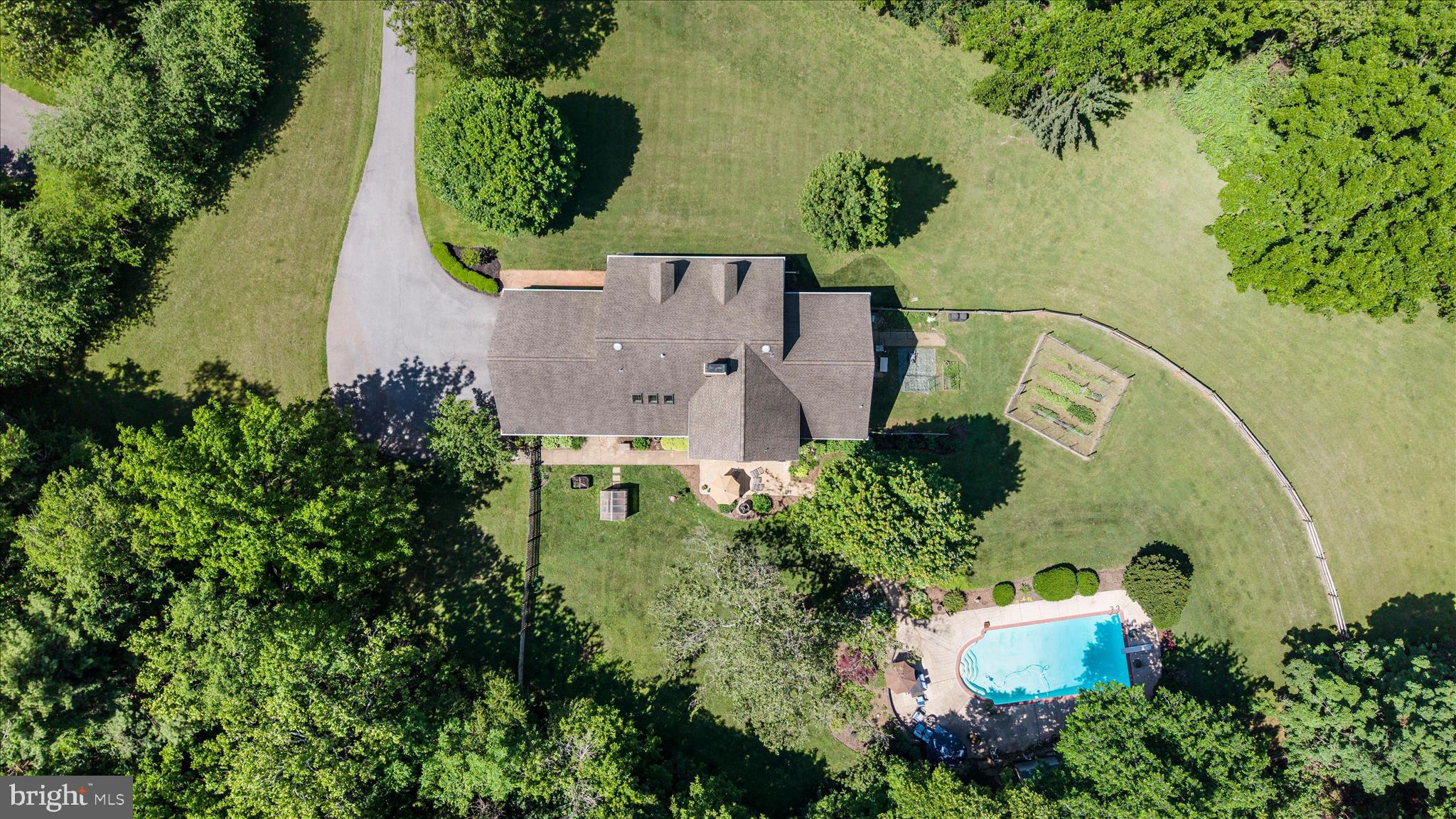 Custom built by Ausherman Builders, this stately all-brick estate offers the perfect blend of quality craftsmanship, generous living spaces and features, all with a sense of privacy. From the moment you step into the foyer, you'll appreciate the home's thoughtful design, impressive scale, and inviting atmosphere.  The main level features expansive rooms throughout, including a formal family room, elegant dining room, and a spacious living room centered around a cozy fireplace. A convenient main-level bedroom and full bath provide flexibility for guests.  Filled with natural light, the beautifully updated kitchen serves as the heart of the home, featuring new flooring, backsplash, and an open-concept layout that flows seamlessly into the breakfast area, where a pellet stove creates the perfect setting for relaxed mornings and intimate gatherings.  Designed for everyday convenience, the home also offers a mudroom with abundant storage, an oversized laundry room with custom cabinetry, and a main-level powder room.  Upstairs, you'll find 5 additional spacious bedrooms and 3 bathrooms.  The owners' suite includes a newly remodeled bathroom.  The fully finished walkout lower level expands your living and entertaining options with an additional family room featuring a pellet stove, a bonus room, full bath, workshop, and extensive storage space.  Step outside to your own private resort-style retreat. The backyard showcases a beautiful Gunite pool, a fountain, greenhouse, thriving vegetable garden, potting station, spacious patio, and additional storage beneath the porch—creating an outdoor oasis ideal for entertaining, gardening, or simply enjoying the peaceful surroundings.   Beyond its impressive living spaces and resort-style outdoor amenities, this home has been meticulously maintained and thoughtfully updated. Recent improvements include a new water heater in 2024, replacement well pump in 2018, 23 upgraded windows and a repaved driveway in 2013, as well as HVAC systems replaced in 2022 and 2014 with continuous maintenance contracts. The fireplaces, HVAC systems, and water treatment equipment have received consistent annual maintenance, while the septic system has been recently serviced. A 12.5 kW Generac whole-house generator with transfer switch further enhances the home's comfort, reliability, and peace of mind.   Offering remarkable space, enduring quality, and an unparalleled outdoor setting, this distinguished estate presents a rare opportunity to enjoy luxury living in a truly spectacular location.   No HOA and Middletown Schools!  Timeless Elegance, Exceptional Space & Breathtaking Views!