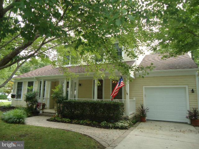 Beautiful home on 1/2 acre lot in sought after Hunt Meadow. Lots of hardwood floors, main-level owner suite with upgraded bath, walk-in closet. Fully finished lower level with kitchenette, full bath, extra washer/dryer hookup. Great family oriented community with community pool, tennis courts, sidewalks, walking path to Quiet Waters.Dead end street. French drain in basement. Stone Fireplace.