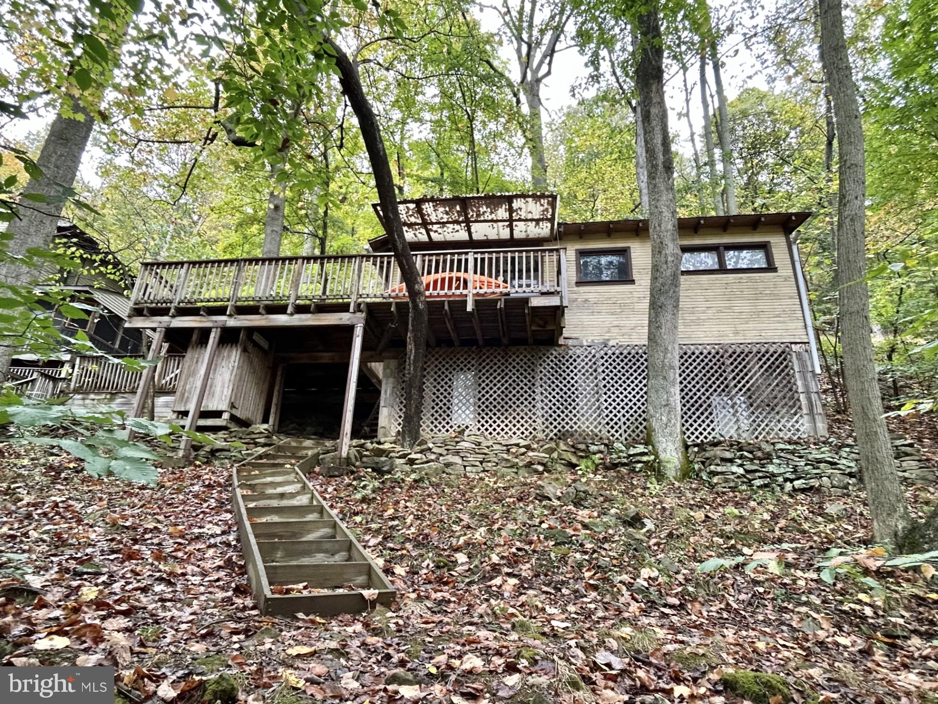 Ever dreamed of owning your own getaway on Yough Lake with your own personal boat dock and boat slip? (a very rare find in the area) - permit conveys as well.  Here is your chance!! Secluded seasonal cabin which sits right on Yough Lake. Amazing relaxing oasis. Yet, not far from the hiking/biking trail, several fishing streams/rivers. Just a few miles from Ohiopyle, Nemacolin Resort, Seven Springs and Hidden Valley resorts. Not far from several golf courses, short drive to Deep Creek Lake area. The best of both worlds awaits!