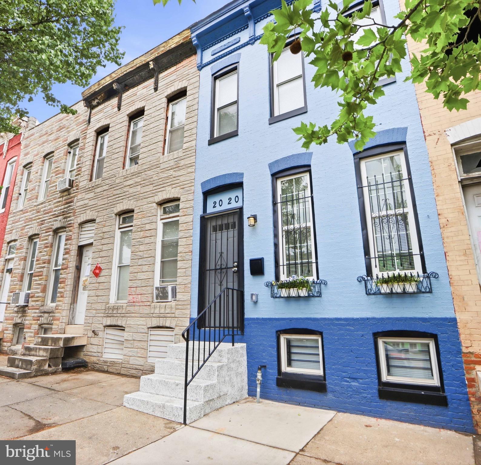 Beautifully renovated Baltimore rowhome featuring an open floor plan, exposed brick accents, recessed lighting, and modern finishes throughout. The updated kitchen offers white cabinets, butcher block countertops, and stainless steel appliances. Spacious bedrooms, a stylishly renovated bathroom, in-unit laundry, and a private fenced rear parking pad complete this move-in-ready home. Conveniently located near downtown & major commuter routes.