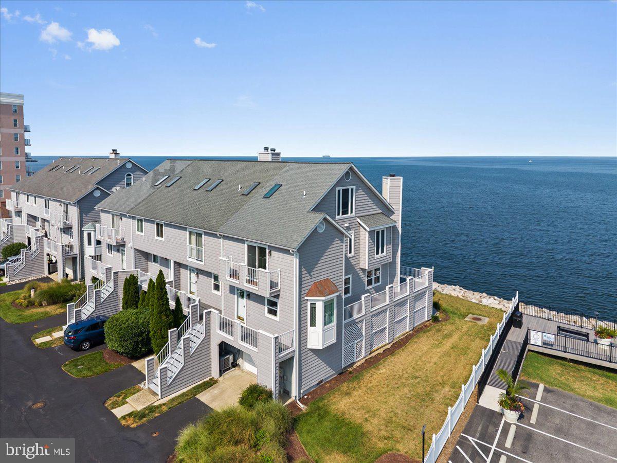 Rich solid bamboo flooring flows throughout the main living areas, while replacement windows maximize the breathtaking Bay views. The remodeled gourmet kitchen features quartz countertops, stainless steel appliances, and opens to a full-width waterfront deck—perfect for morning coffee, outdoor dining, or simply watching the boats pass by.

The spacious family room also opens onto a private waterfront deck, creating seamless indoor and outdoor living. Upstairs, the primary suite becomes your personal waterfront retreat with its own private deck overlooking the Chesapeake Bay, beautifully updated bath, and the convenience of a dedicated washer and dryer. Two additional bedrooms enjoy water views as well, allowing family and guests to wake up to the beauty of the Bay every day.

The walk-out lower level offers even more flexibility with a second washer and dryer, access to a stamped concrete waterfront patio, and a covered sitting area just steps from the shoreline—an ideal place to unwind after a day on the water.

Residents enjoy exclusive access to a private community pier complete with a boat lift and fishing opportunities. Every Independence Day, neighbors gather to watch the spectacular fireworks display reflected across the Chesapeake Bay, creating a tradition you'll look forward to year after year.

Located less than an hour from Washington, D.C., this home offers an exceptional primary residence, weekend escape, or second home without the hassle of Bay Bridge traffic. Enjoy the charm of Chesapeake Beach with its waterfront boardwalk, community beach, farmers markets, local breweries, boutique shopping, restaurants, outdoor concerts, marinas, and year-round events—all just minutes from your door.

If you've been searching for true Chesapeake Bay waterfront living with modern updates, unforgettable views, and an unbeatable coastal lifestyle, this is the one.